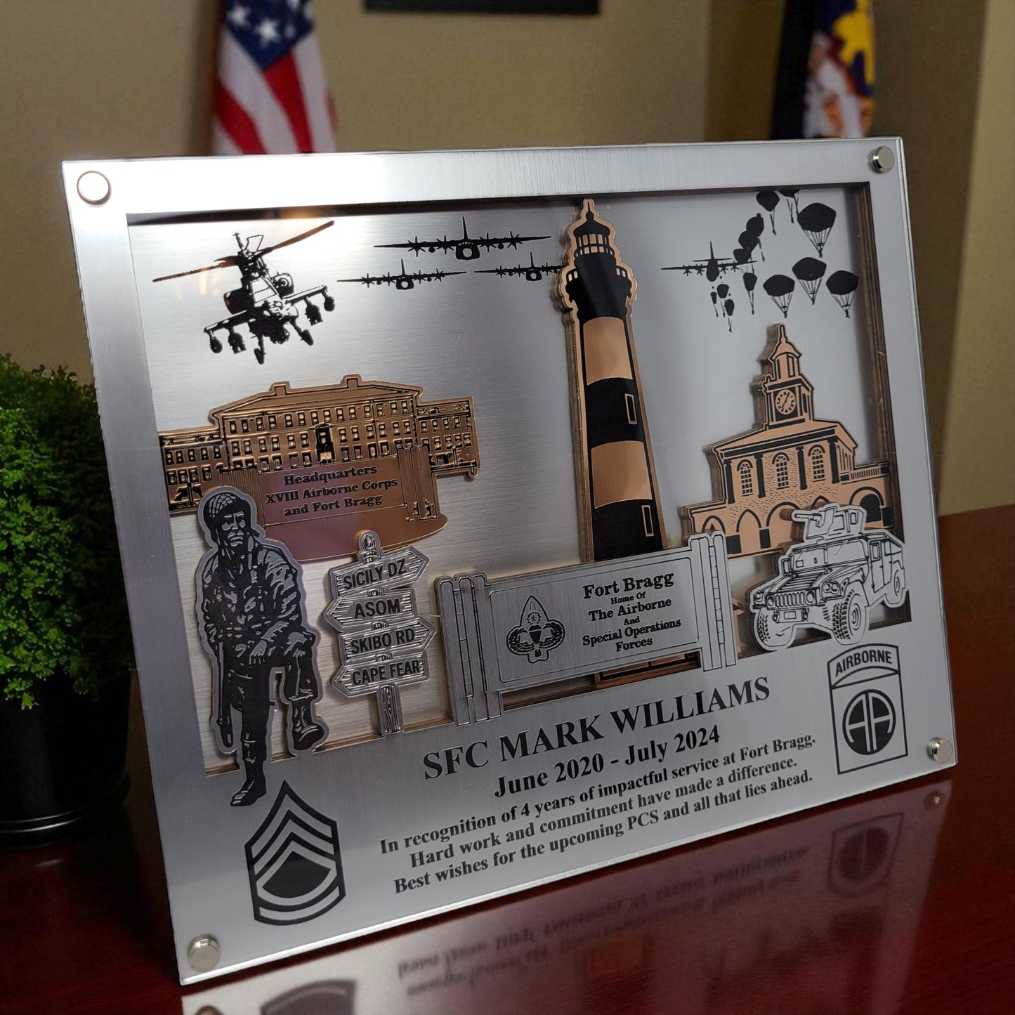 Decorative plaque with military-themed elements and text on a wooden surface. Fort Bragg, Army PCS Gift for Fort Bragg, Fort Liberty PCS Gift