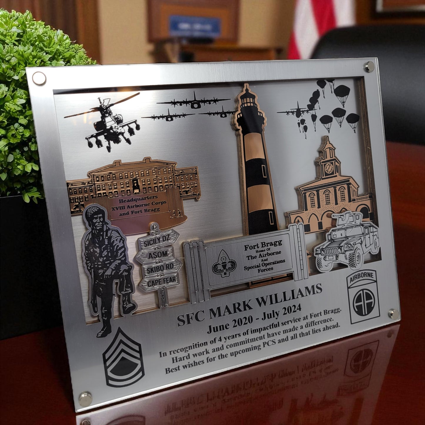 Decorative plaque with military-themed elements and text on a wooden surface. Fort Bragg, Army PCS Gift for Fort Bragg, Fort Liberty PCS Gift