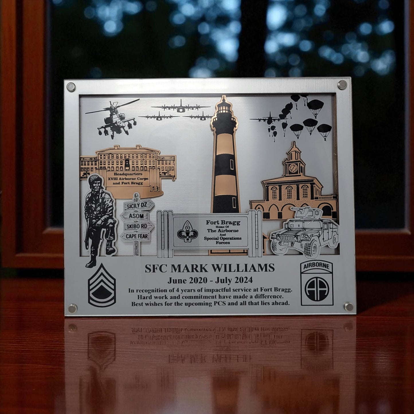 Decorative plaque with military-themed elements and text on a wooden surface. Fort Bragg, Army PCS Gift for Fort Bragg, Fort Liberty PCS Gift