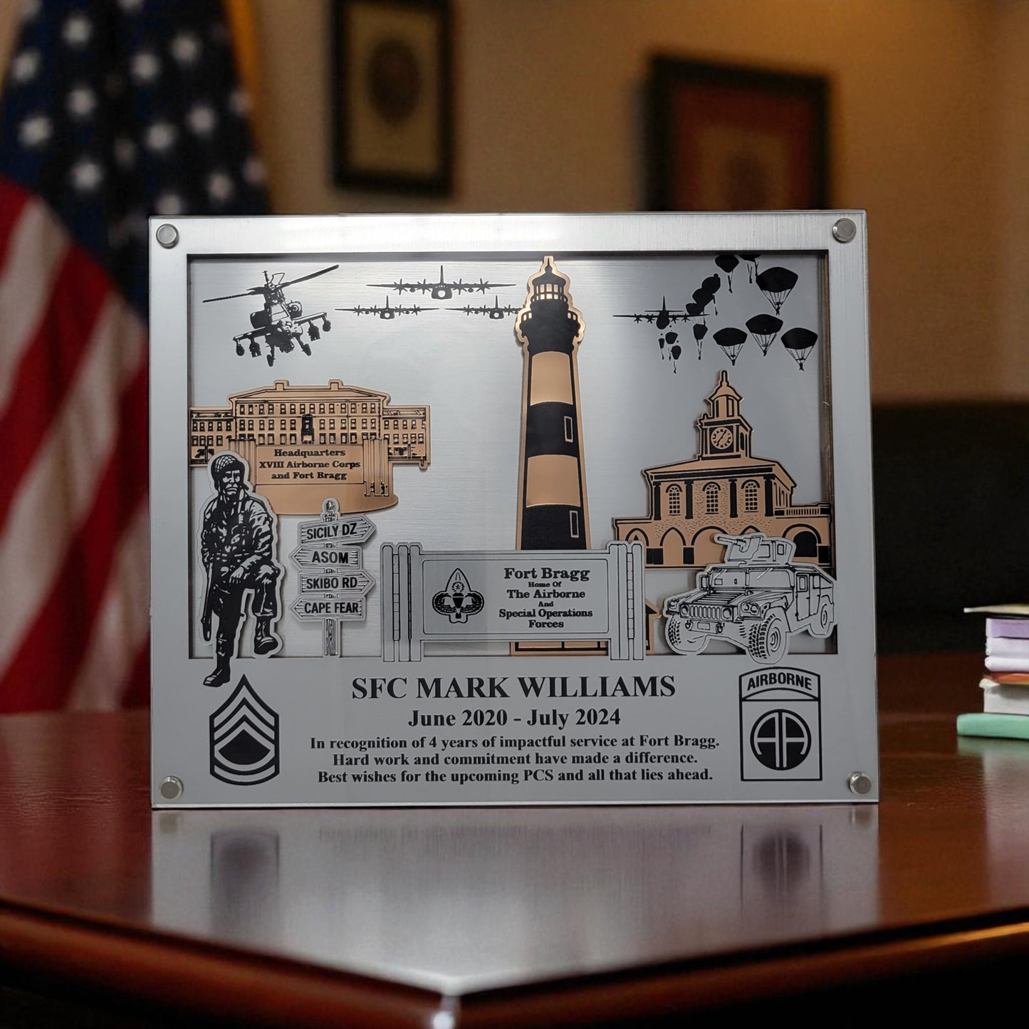 Decorative plaque with military-themed elements and text on a wooden surface. Fort Bragg, Army PCS Gift for Fort Bragg, Fort Liberty PCS Gift