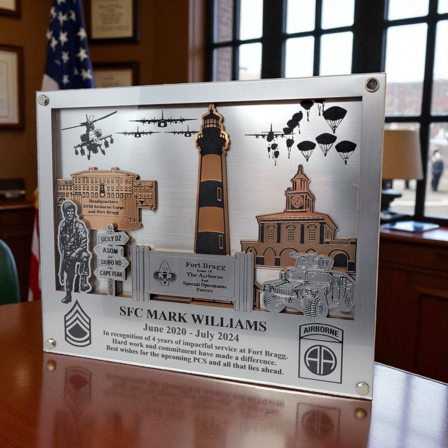Decorative plaque with military-themed elements and text on a wooden surface. Fort Bragg, Army PCS Gift for Fort Bragg, Fort Liberty PCS Gift