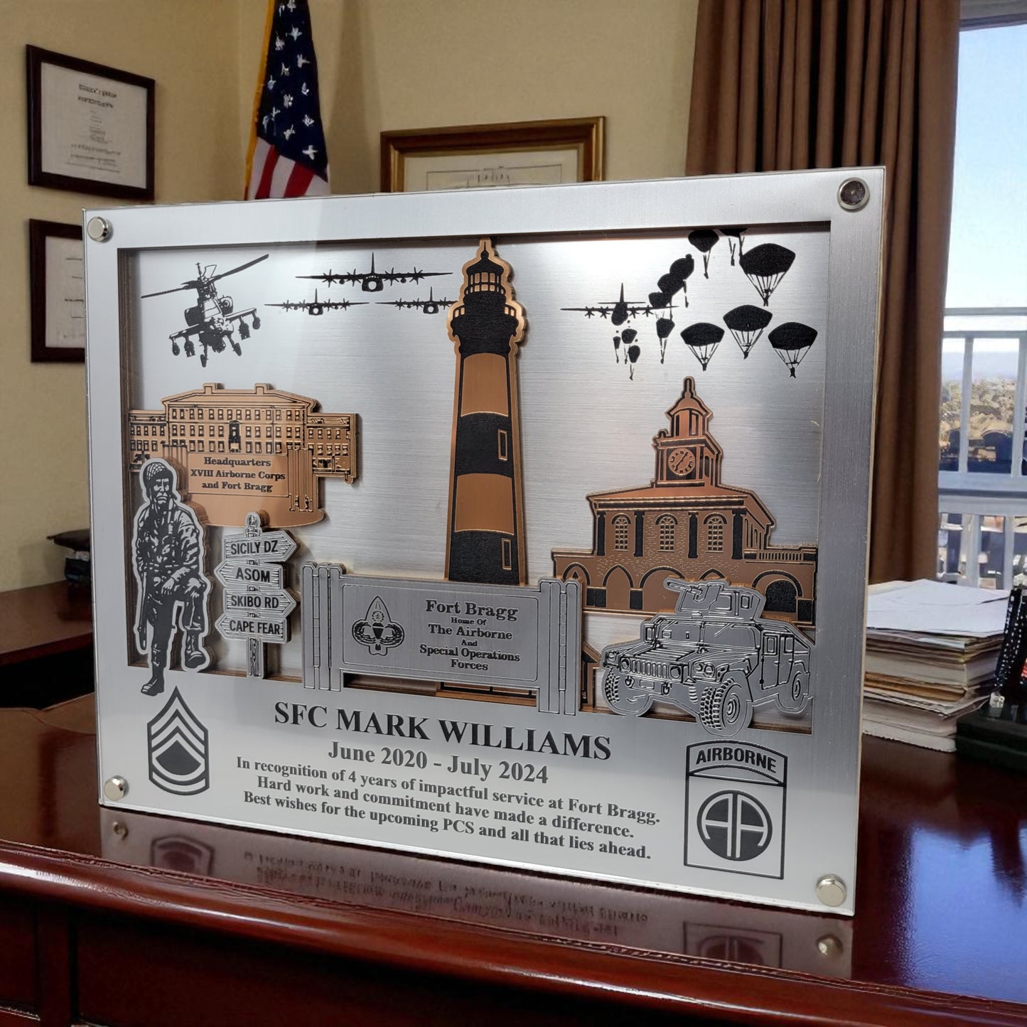 Decorative plaque with military-themed elements and text on a wooden surface. Fort Bragg, Army PCS Gift for Fort Bragg, Fort Liberty PCS Gift