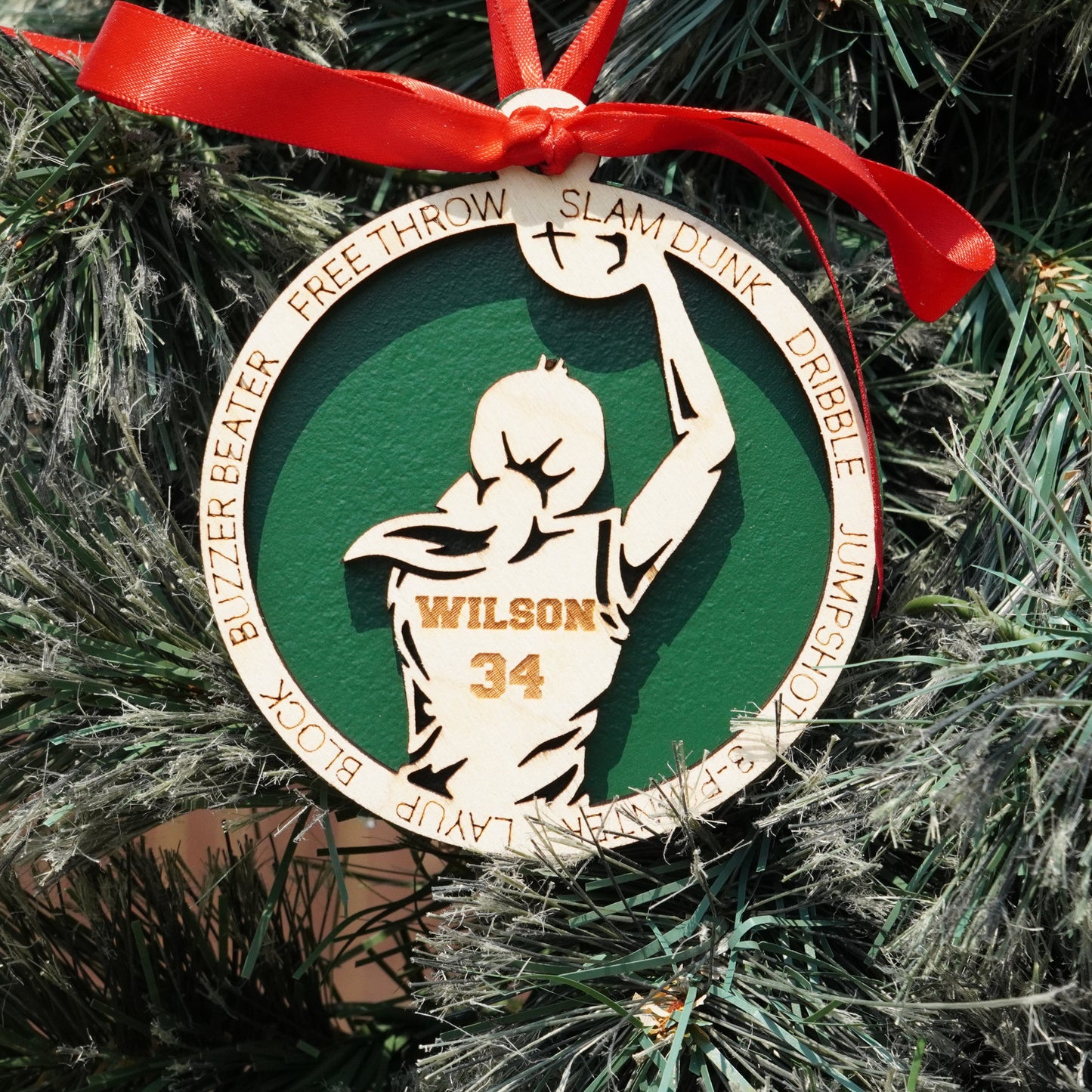 Ornament with a basketball player design on a Christmas tree