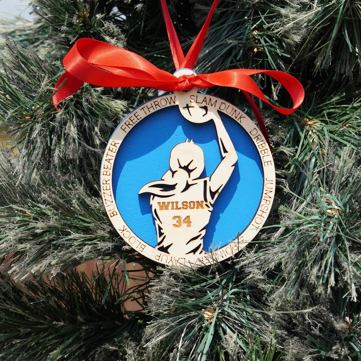 Ornament with a basketball player design on a Christmas tree