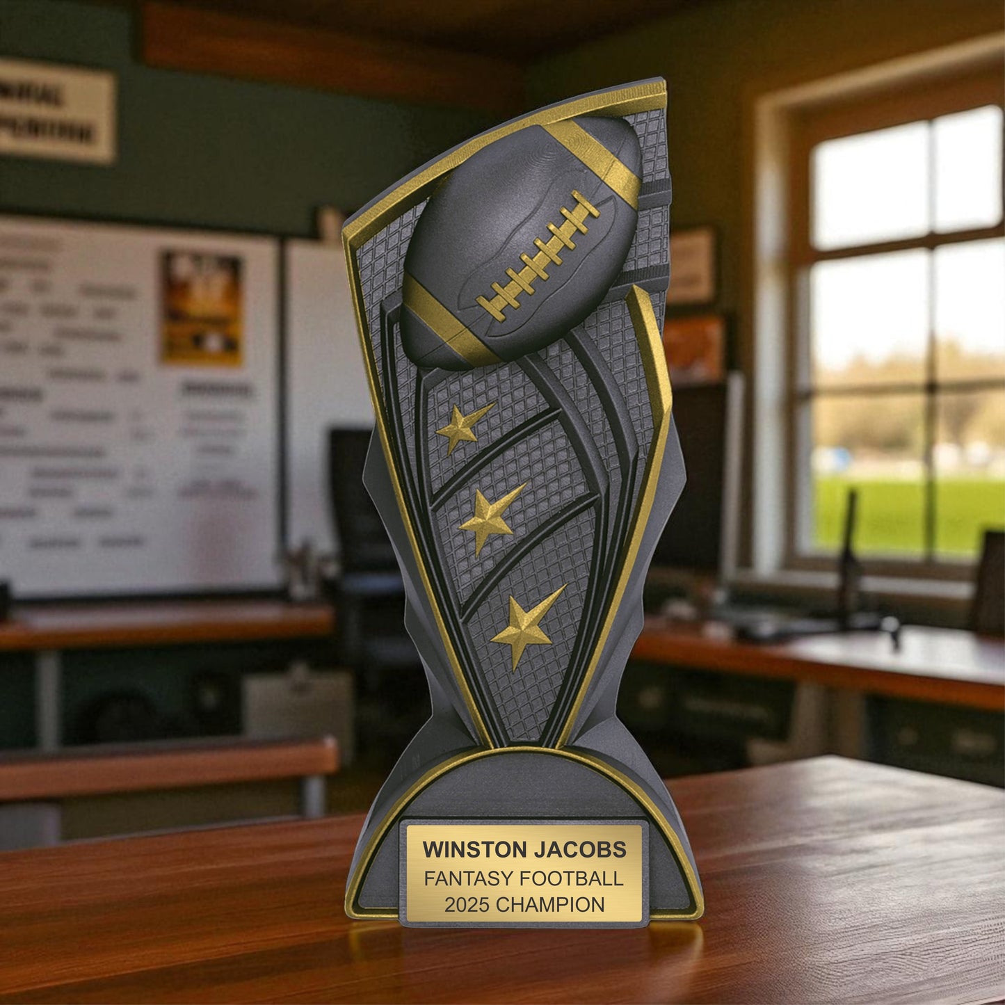 Fantasy football trophy with 'Winston Jacobs' and '2025 Champion' on a wooden table.