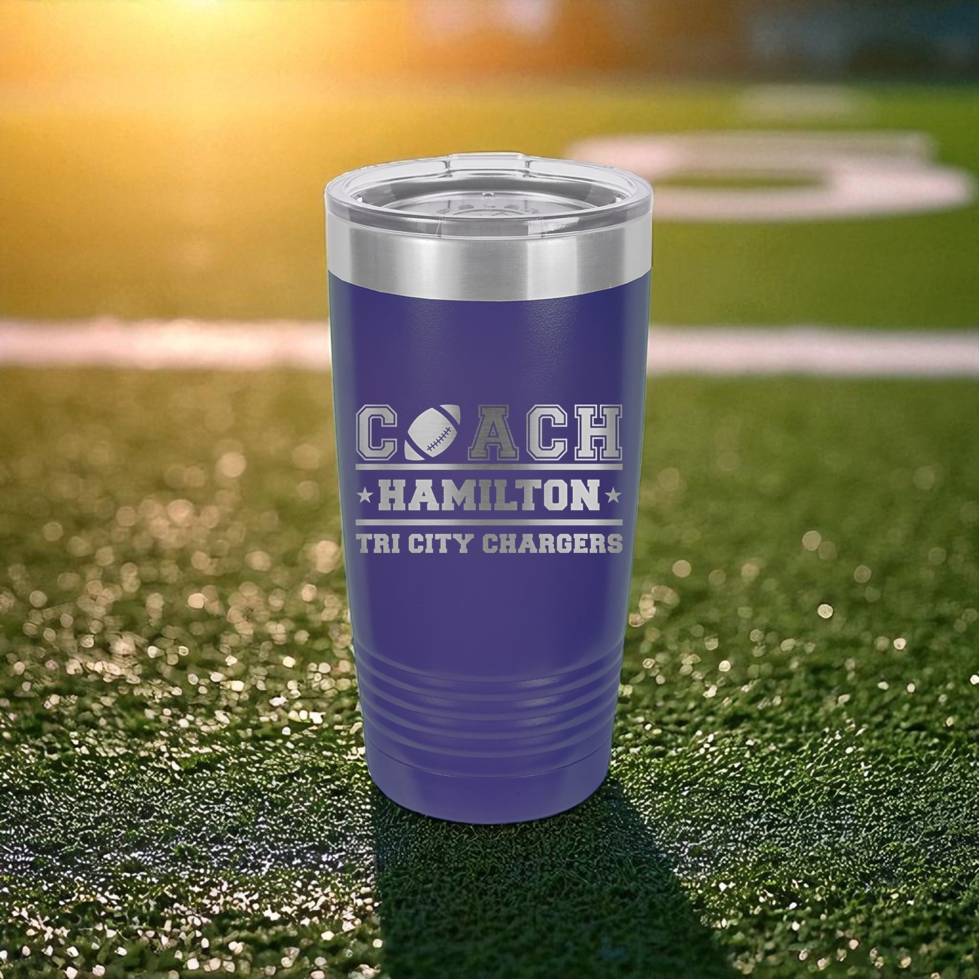 Purple tumbler with 'Coach Hamilton' and 'Tri City Chargers' text on a grassy field background