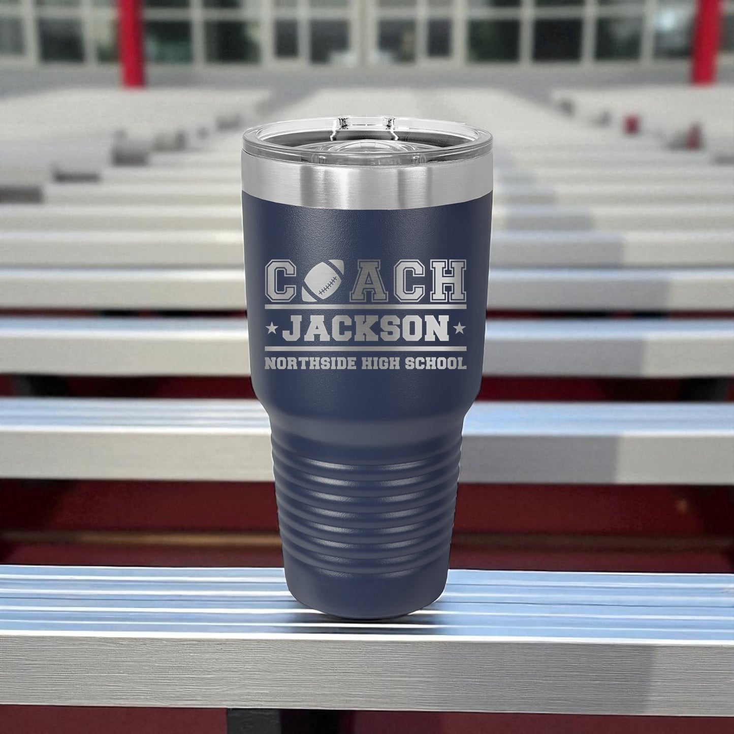 Blue tumbler with 'Coach Jackson Northside High School' text on bleachers
