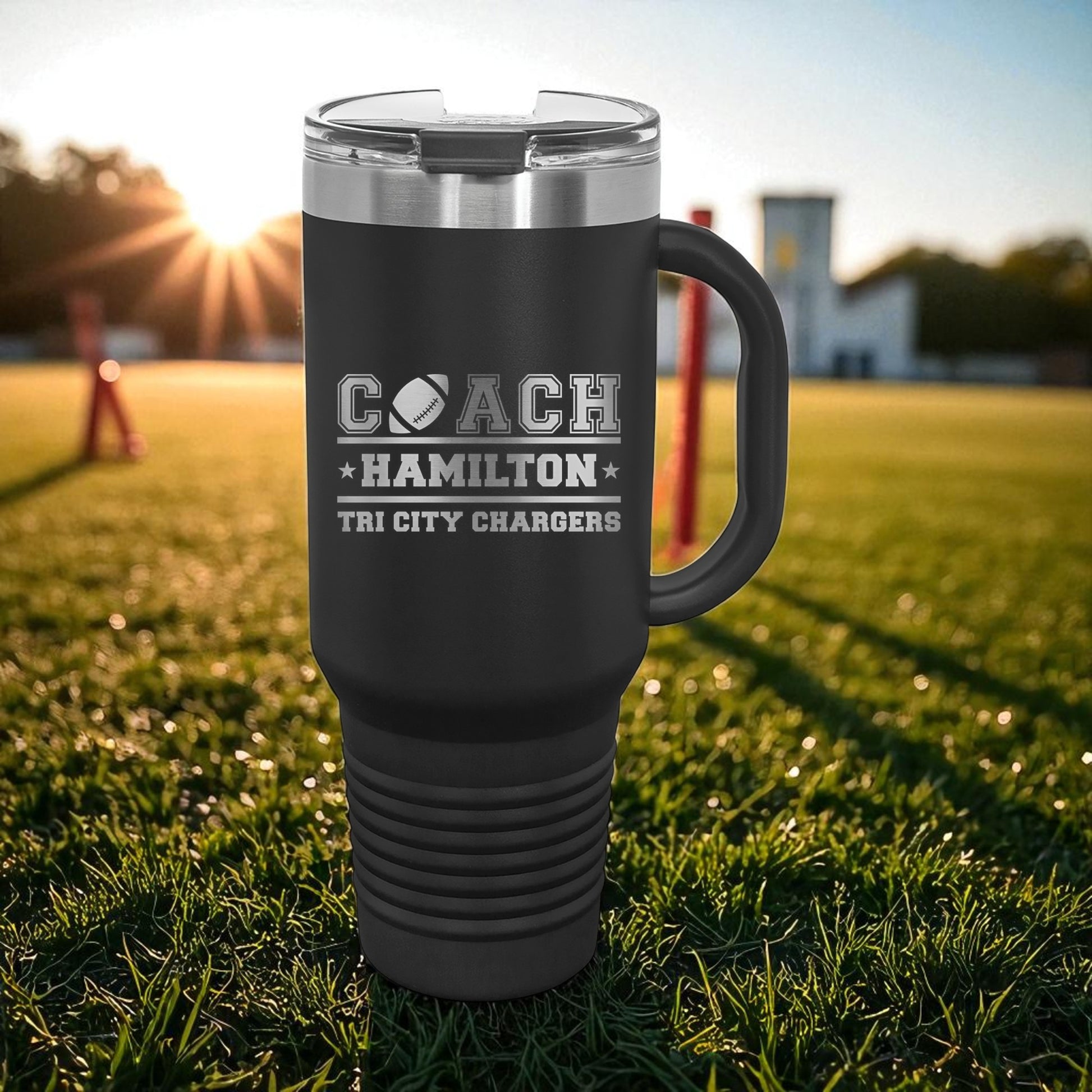 Black travel mug with 'Coach Hamilton Tri City Chargers' text on a grassy field background