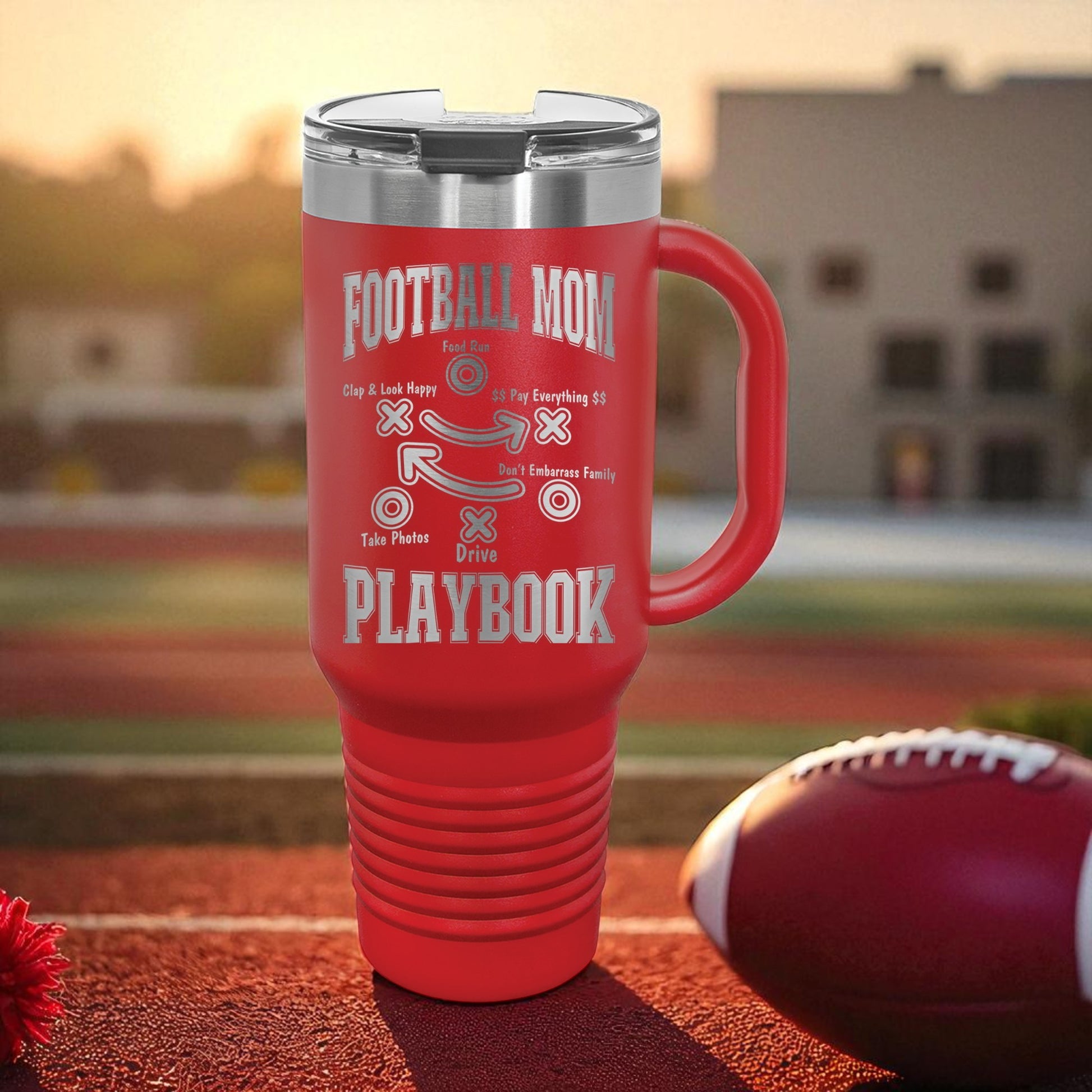 Football Mom Playbook 40oz Stanley Tumbler with Handle — laser-etched stainless steel travel mug made for Friday Night Lights, tailgates, and long tournament days. The Football Mom “Playbook” design is permanently engraved (not printed) so it won’t peel, crack, or fade. Perfect team mom gift, booster club gift, senior night gift, and everyday car cup for busy sports moms.