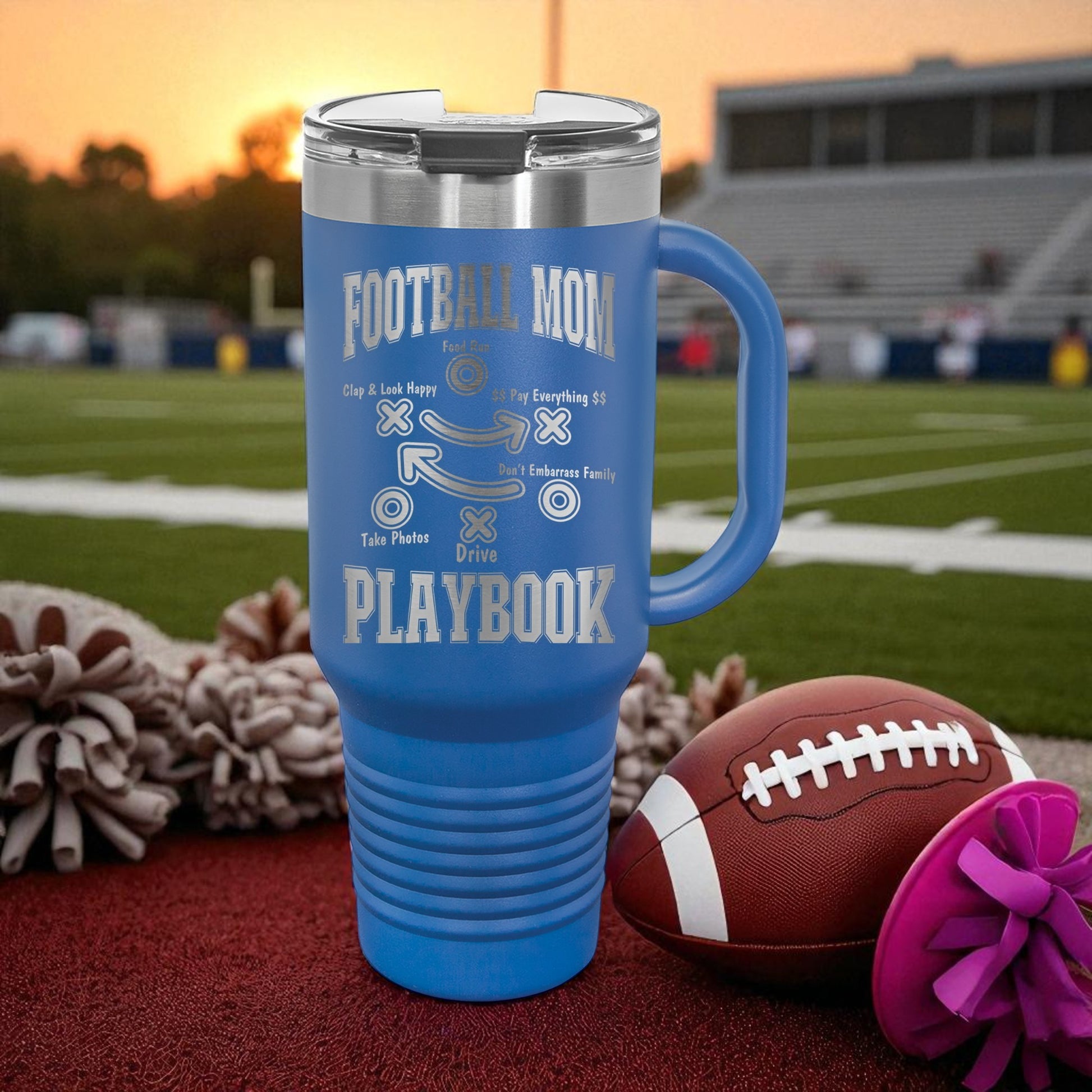 Football Mom Playbook 40oz Stanley Tumbler with Handle — laser-etched stainless steel travel mug made for Friday Night Lights, tailgates, and long tournament days. The Football Mom “Playbook” design is permanently engraved (not printed) so it won’t peel, crack, or fade. Perfect team mom gift, booster club gift, senior night gift, and everyday car cup for busy sports moms.