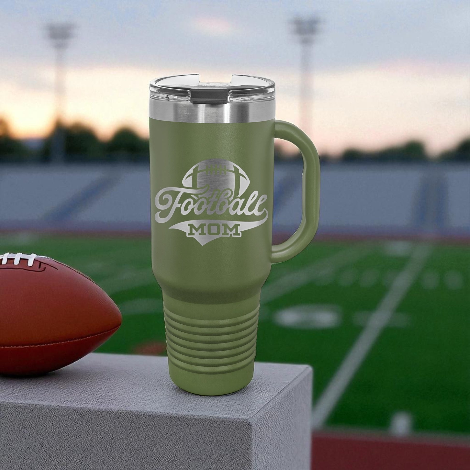 Green travel mug with 'Football Mom' text on a sports field background