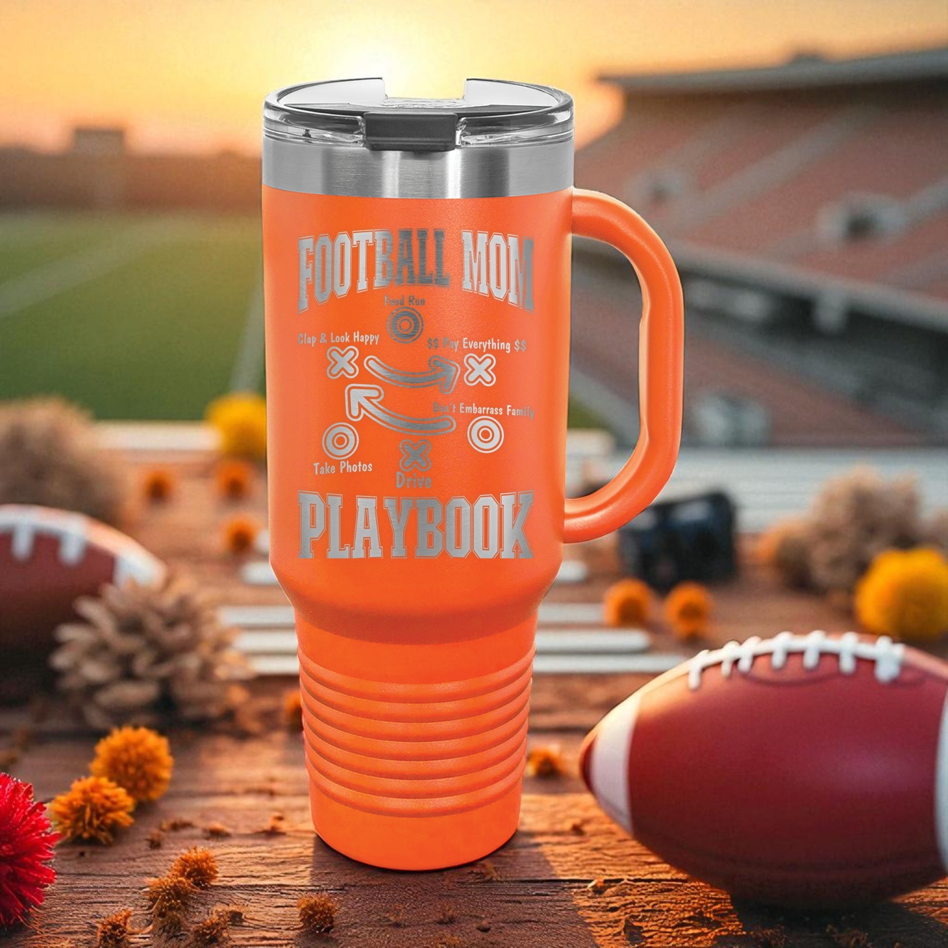 Football Mom Playbook 40oz Stanley Tumbler with Handle — laser-etched stainless steel travel mug made for Friday Night Lights, tailgates, and long tournament days. The Football Mom “Playbook” design is permanently engraved (not printed) so it won’t peel, crack, or fade. Perfect team mom gift, booster club gift, senior night gift, and everyday car cup for busy sports moms.