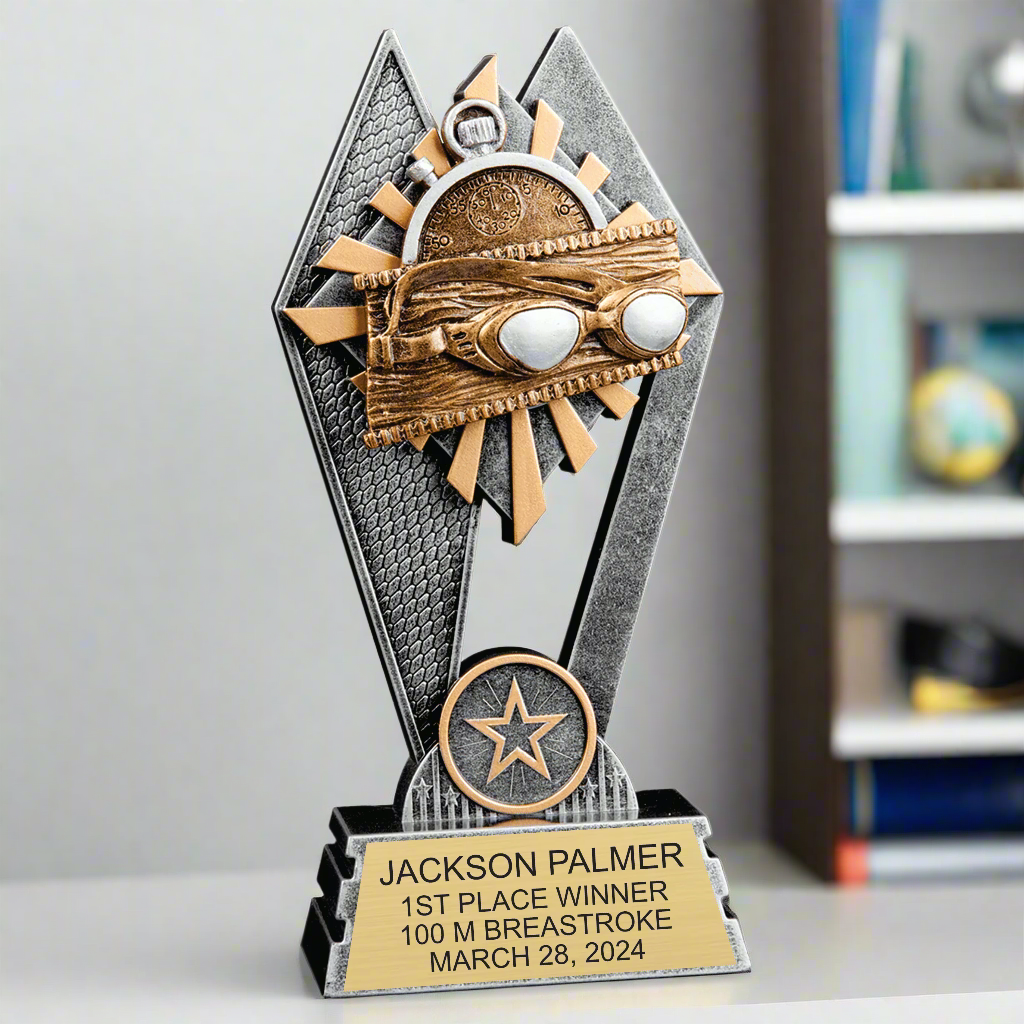 Group of multiple Swimming Sun Ray Award trophies arranged on a table, ready to be presented at a swim meet or award ceremony.