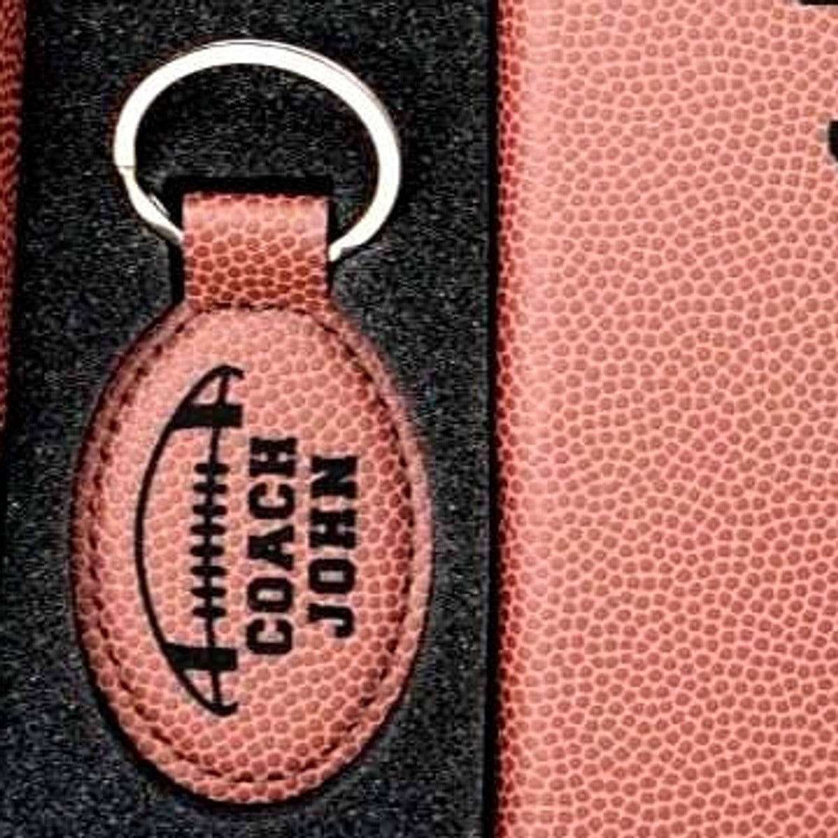 Football leatherette oval keychain laser engraved with a football design and a coach name