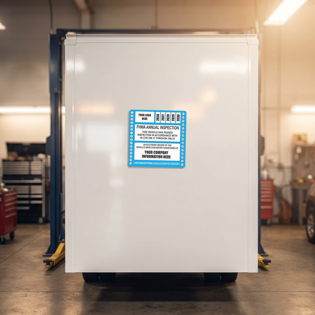FHWA style annual inspection decal mounted on a fleet box truck door showing the 12-month validity window