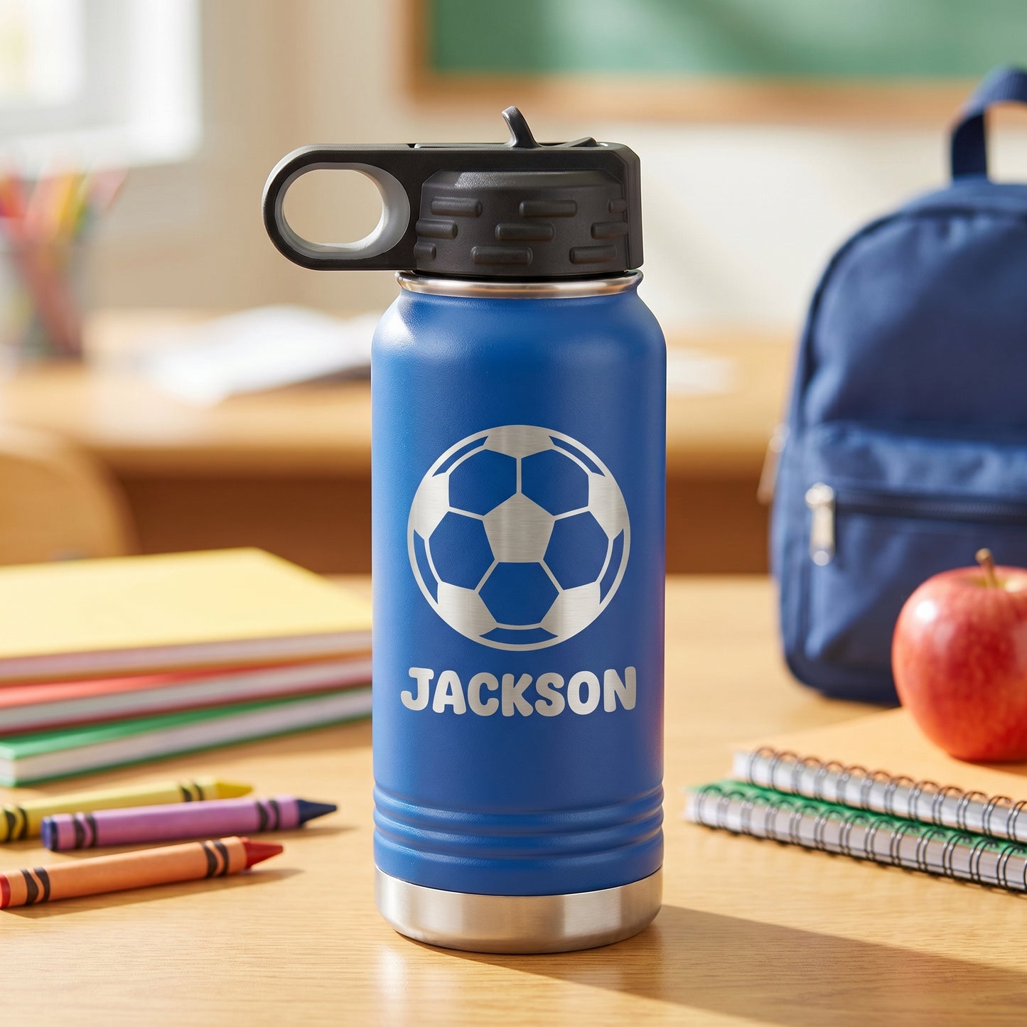 Royal blue personalized kids water bottle with engraved soccer ball design and name