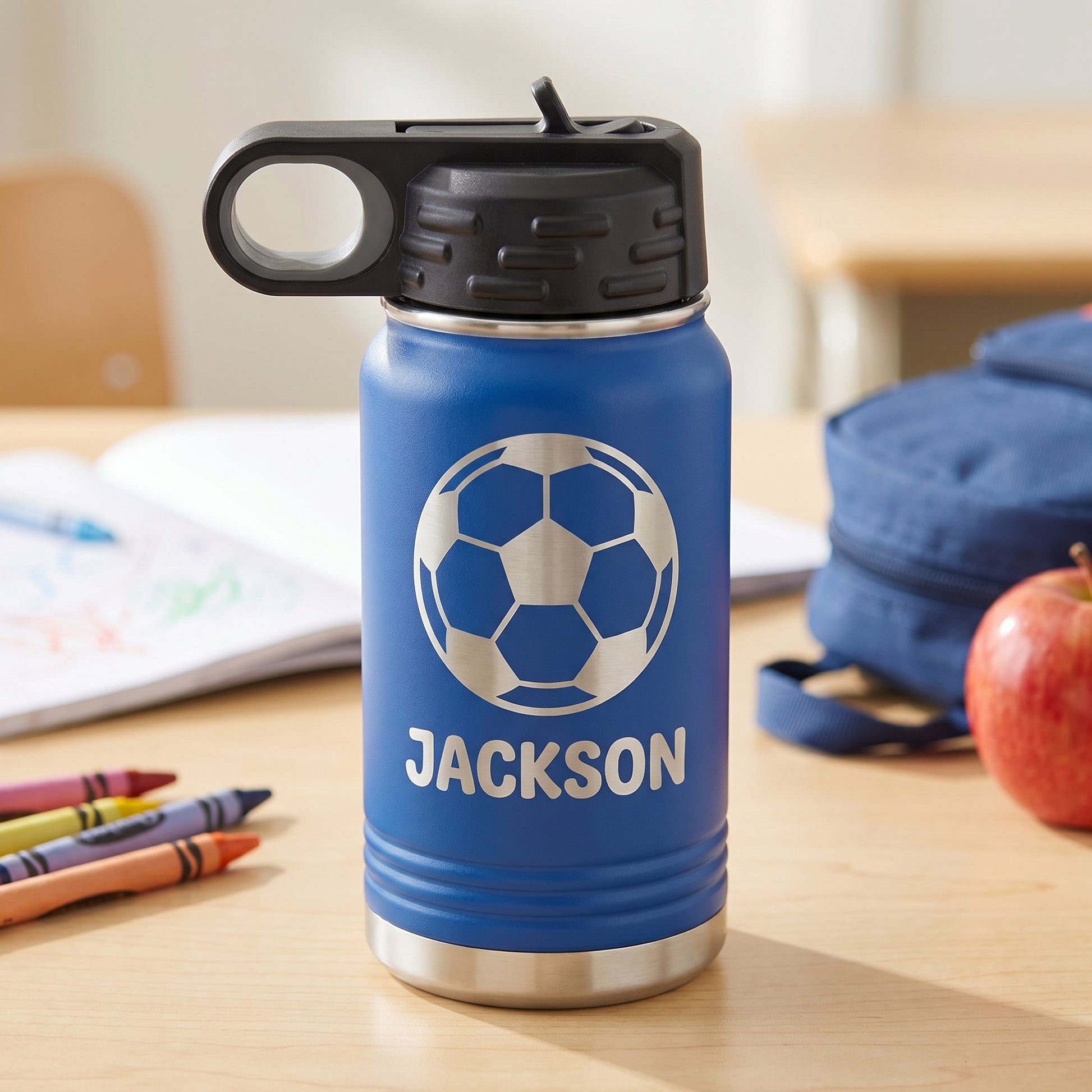 Royal blue personalized kids 12oz water bottle with engraved soccer ball design and name