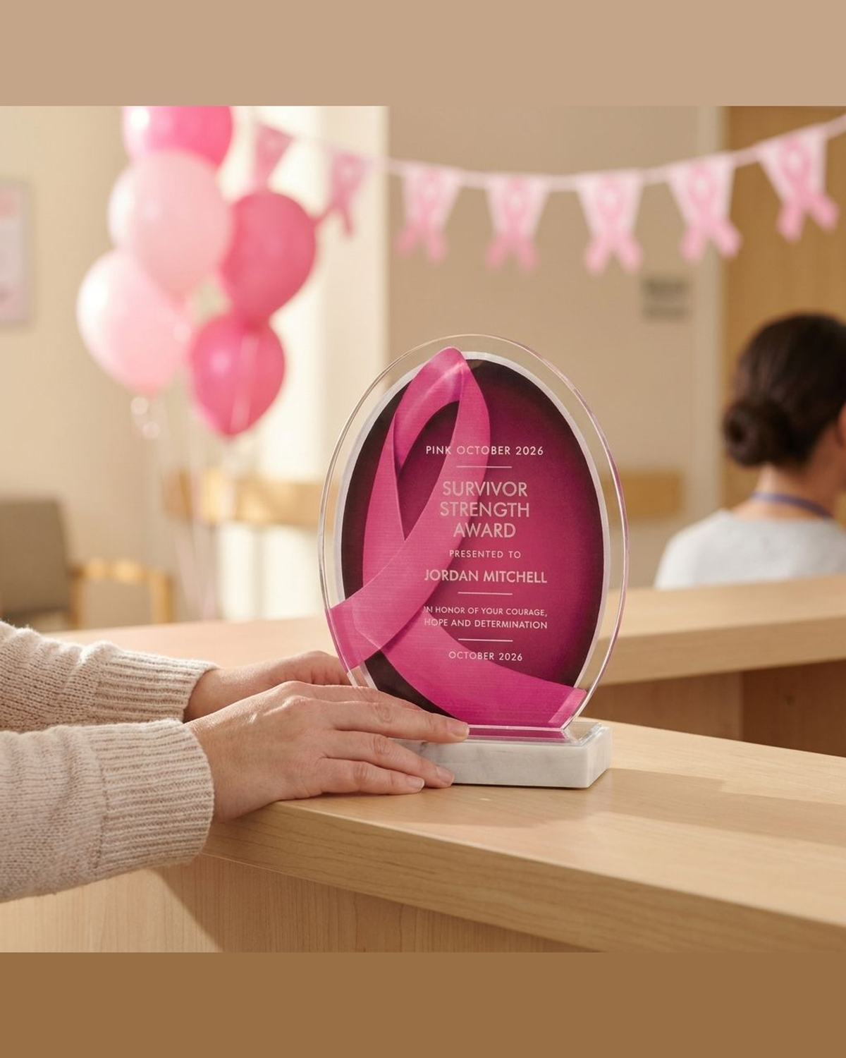 Pink ribbon acrylic breast cancer awareness award being presented at a survivor celebration reception counter, personalized keepsake for oncology nurses and Pink October events