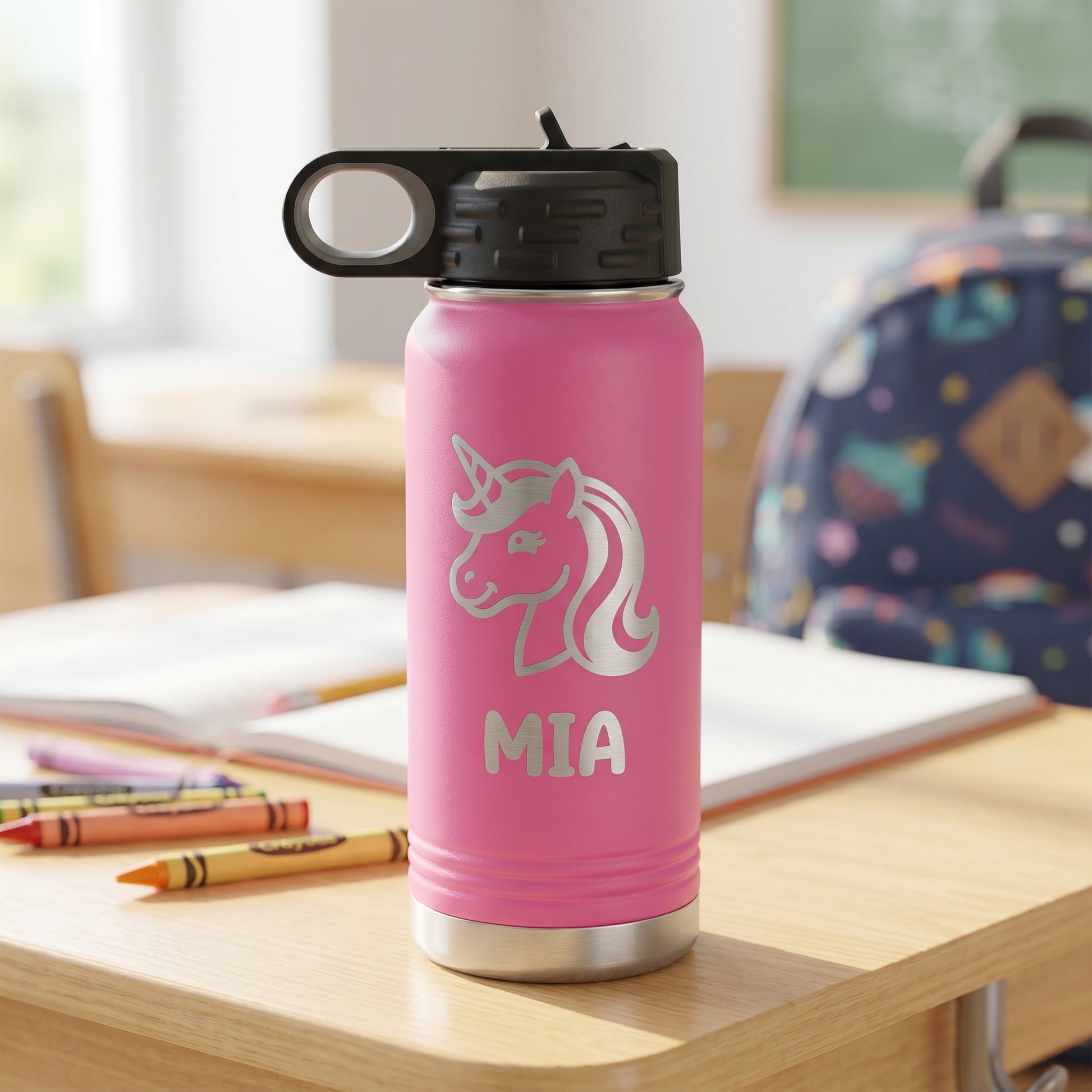 Pink personalized kids water bottle with engraved unicorn design and name