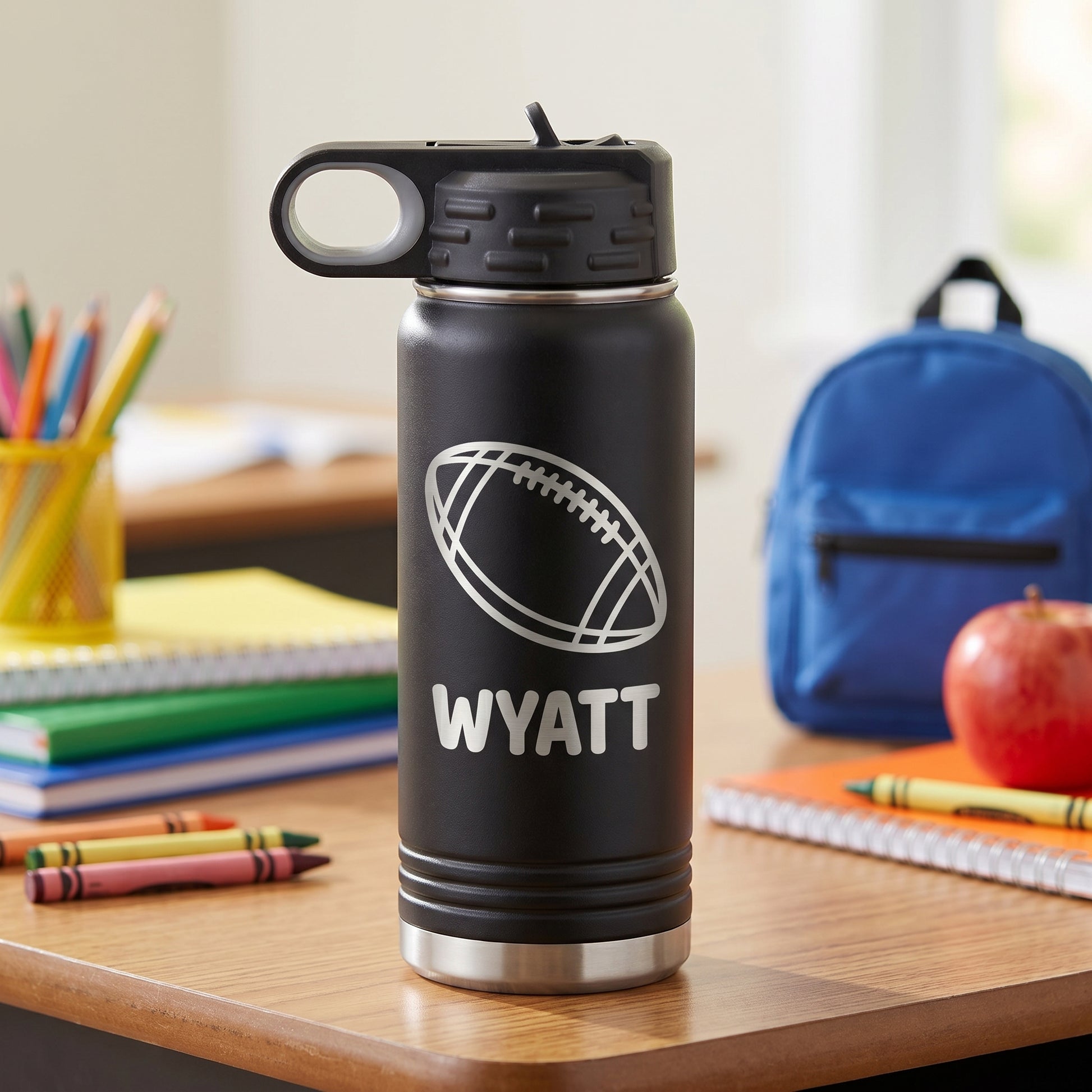 Black personalized kids water bottle with engraved football design and name