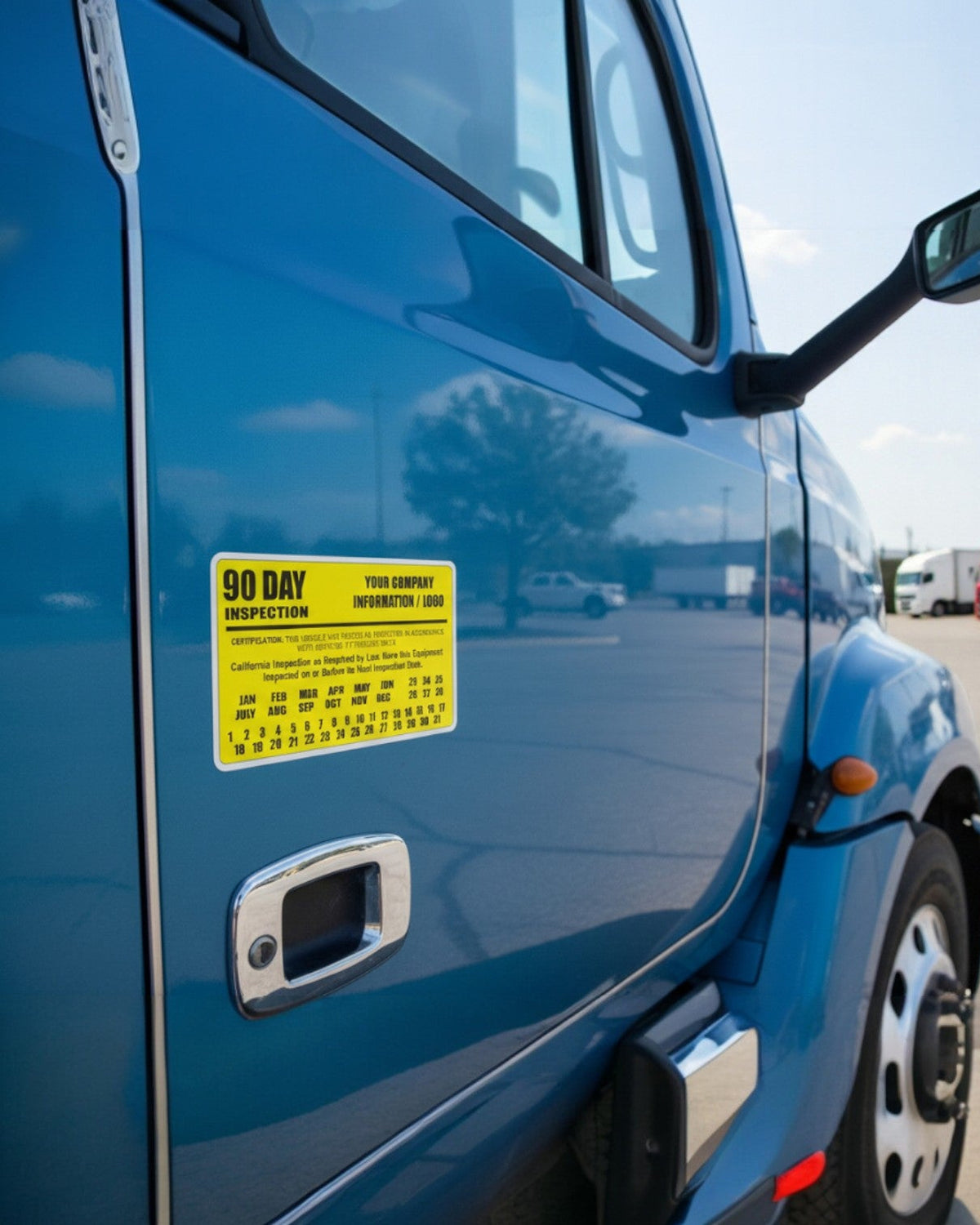 Yellow 90 day BIT inspection label applied to a blue semi truck door, custom company name decal for trucking fleets