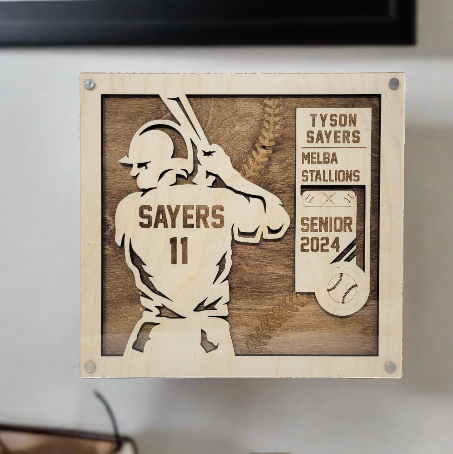 Personalized baseball player plaque with a stained background, professional photography, with a name, year, and team engraved, also personalized with a baseball logo