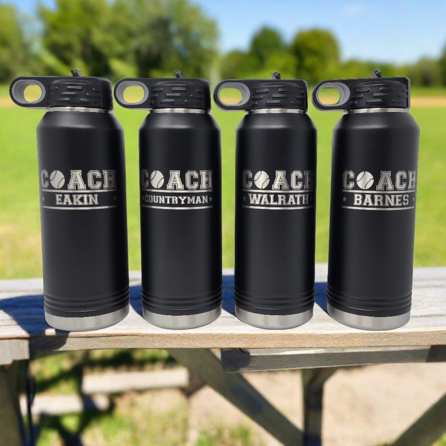 four personalized baseball water bottles on a bench at the baseball field, sunny day, blue sky, professional photography