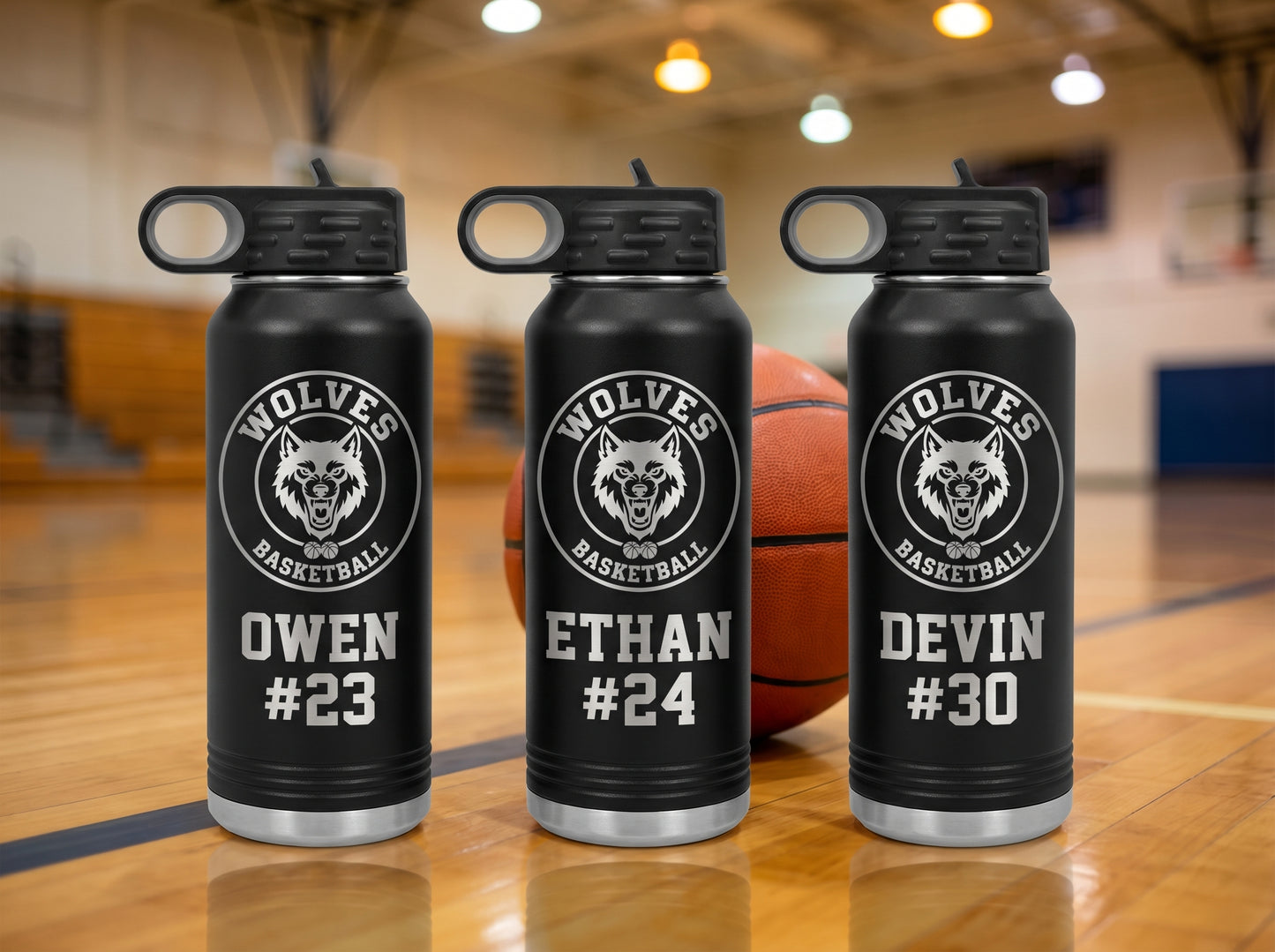 three black basketball team water bottles wolves crest individual player jersey numbers court