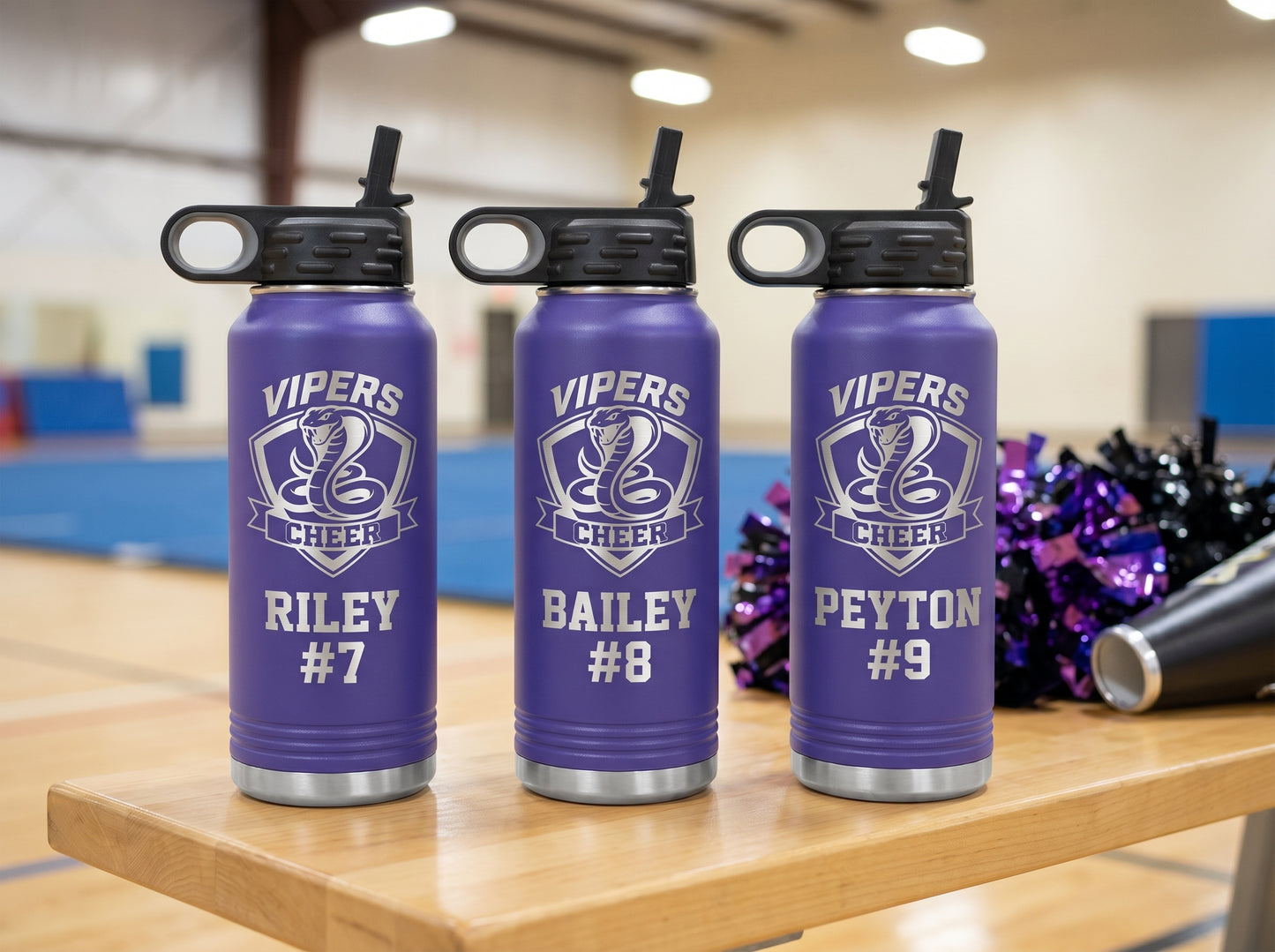 three purple cheer team water bottles with vipers cheer crest and individual roster numbers