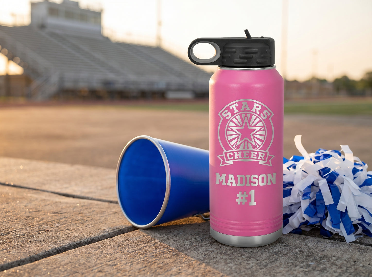 cheer team water bottle on stadium sideline at sunset with megaphone and pom-poms