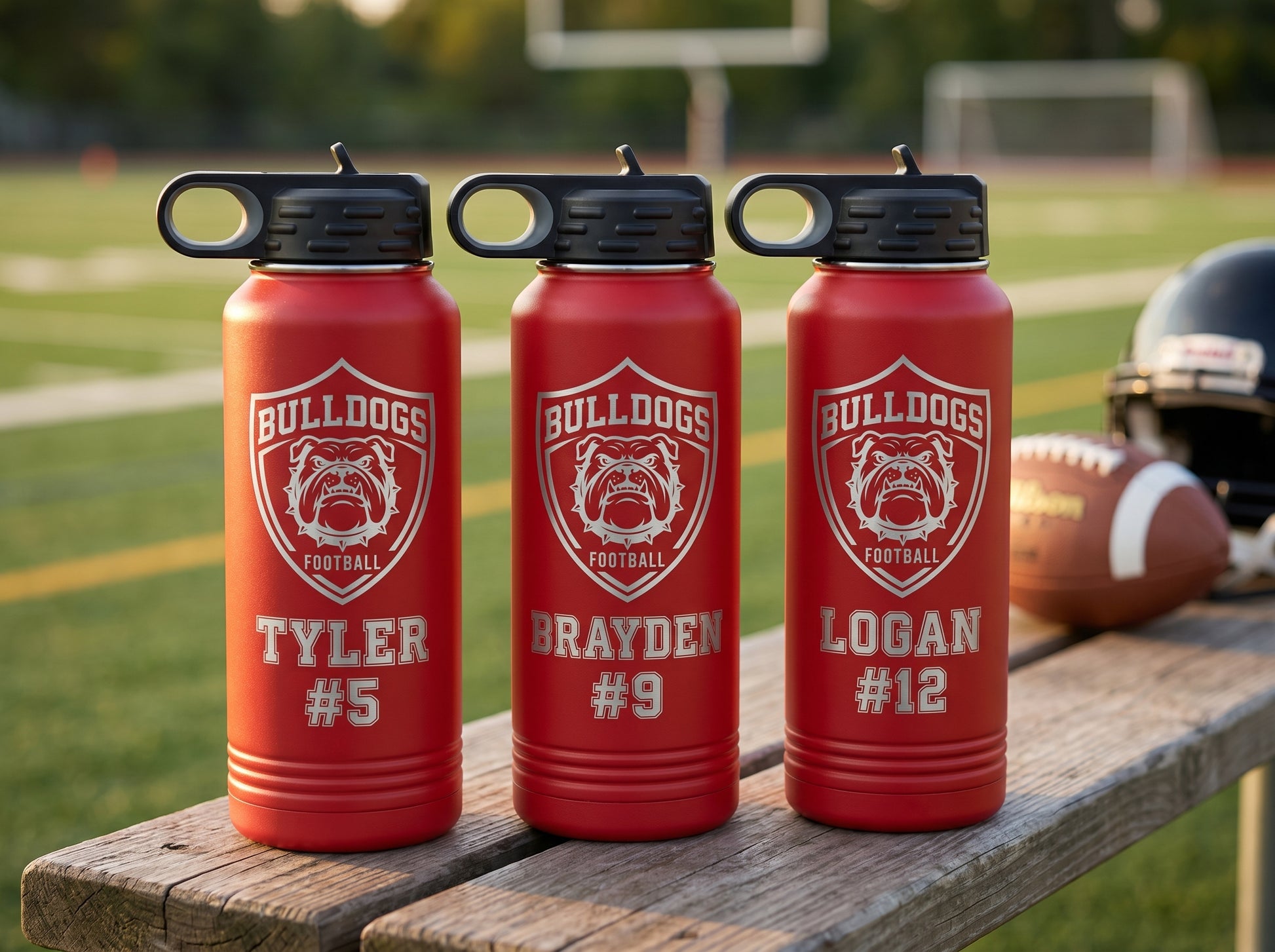 three red football team water bottles personalized with player names and numbers bulldogs