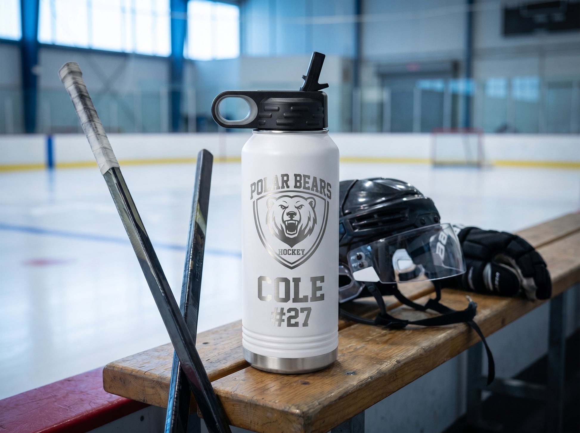 white hockey team water bottle on player bench inside ice rink with stick and helmet