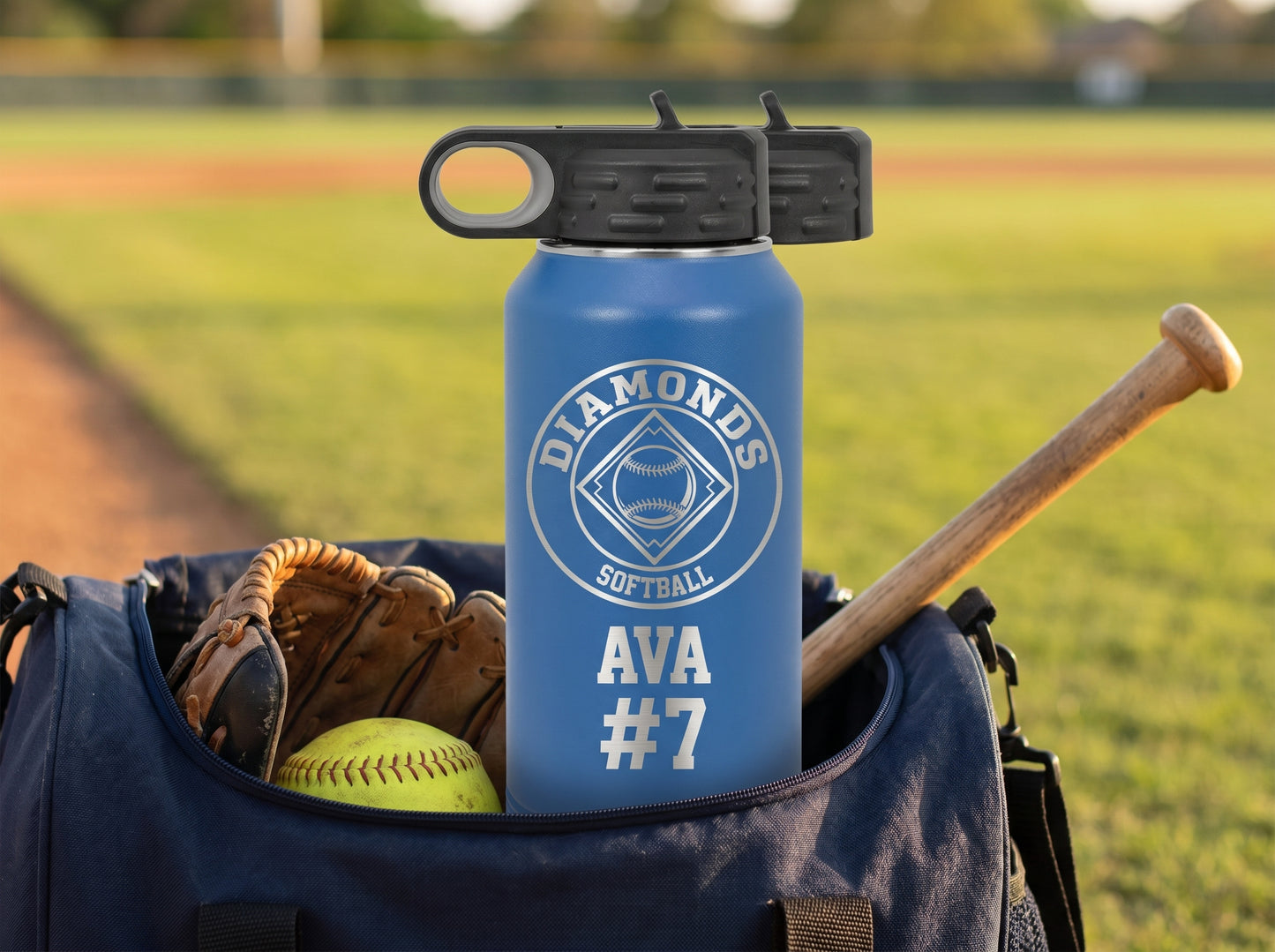 royal blue softball team water bottle resting on gear bag with bat and glove visible
