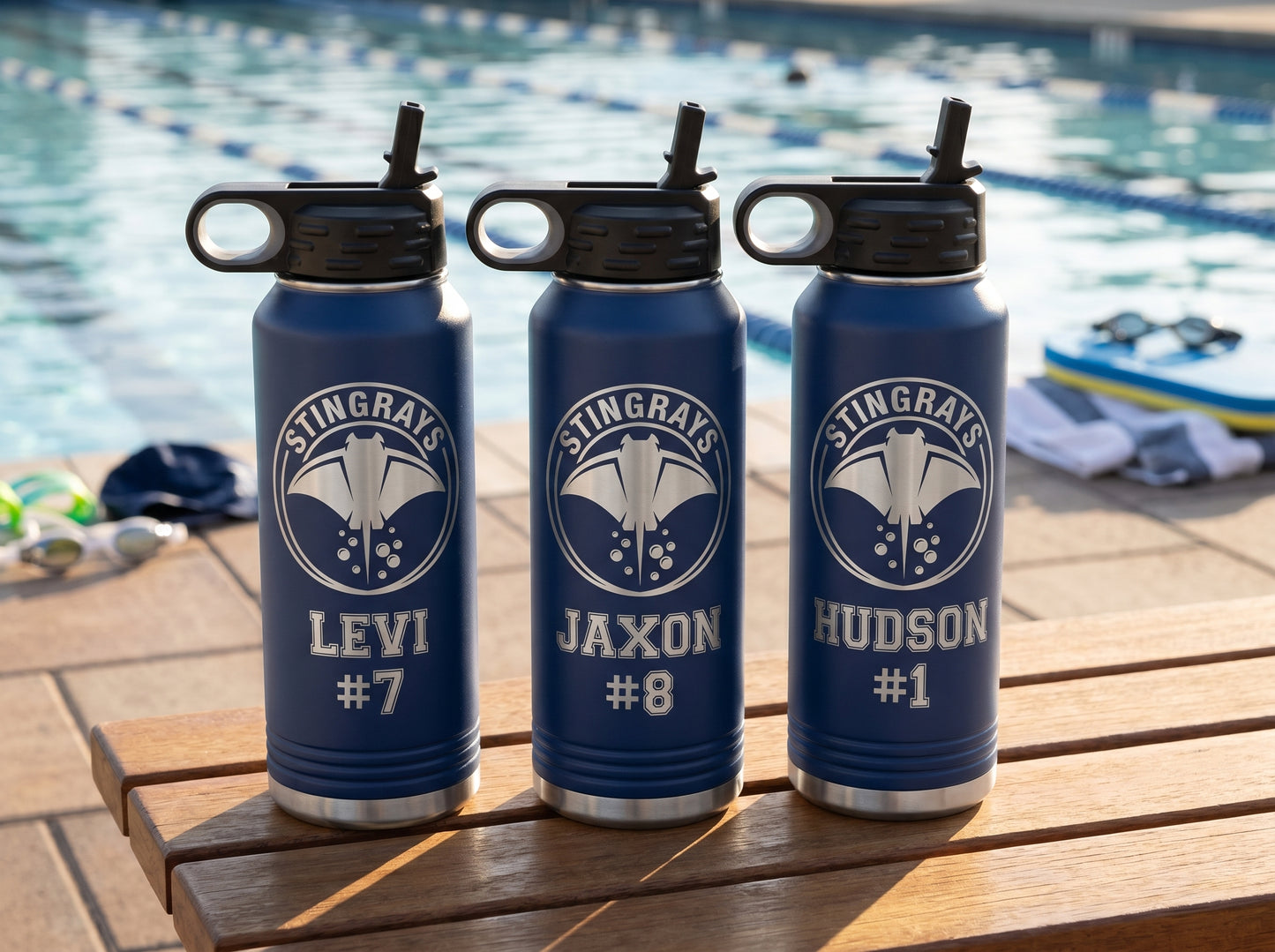 three navy blue swim team water bottles with stingrays crest personalized swimmer names