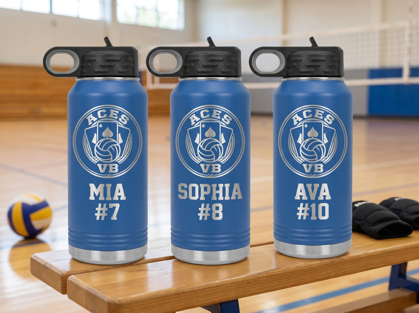 three royal blue volleyball water bottles with team logo and player names lined up on bench