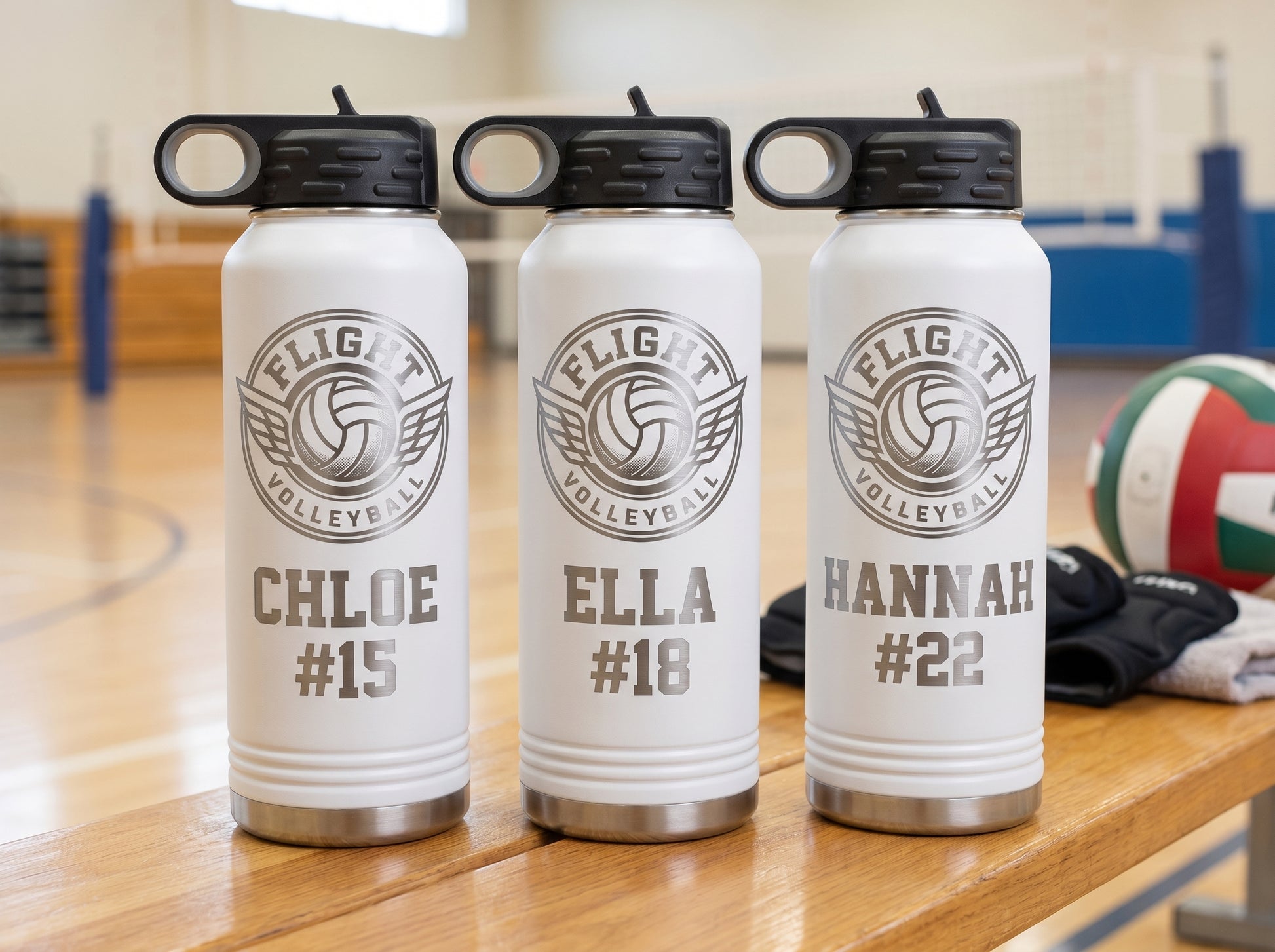 three white volleyball team water bottles personalized with player names and numbers for team roster