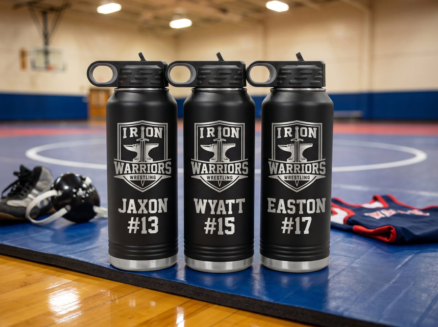 three black wrestling team water bottles with iron warriors crest and individual jersey numbers