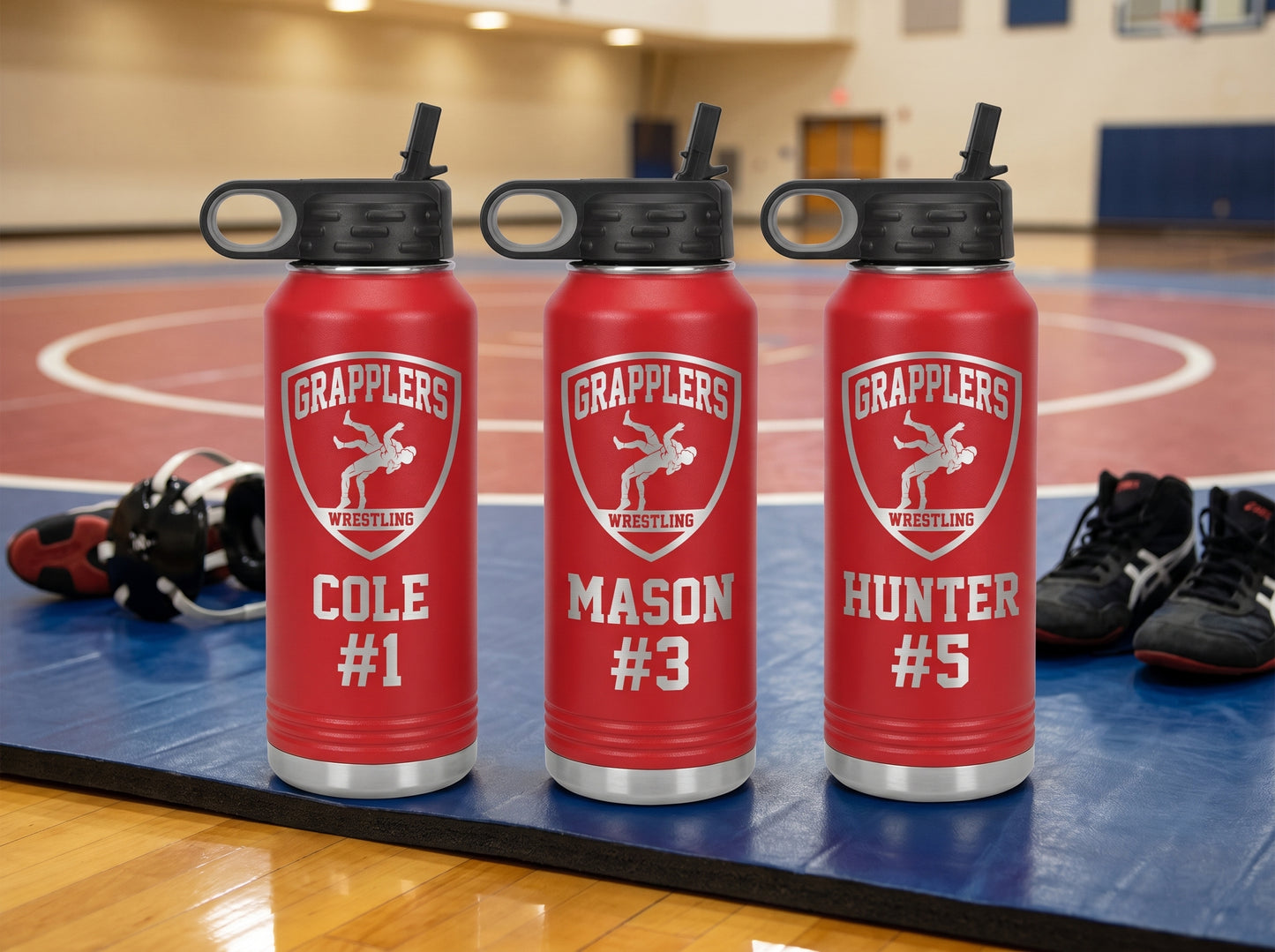three red wrestling team water bottles personalized with wrestler names and numbers grapplers