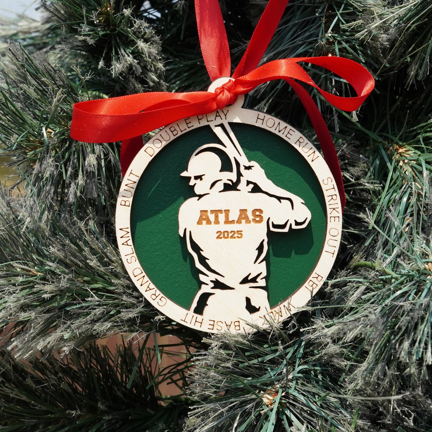 Ornament with a baseball player design on a Christmas tree