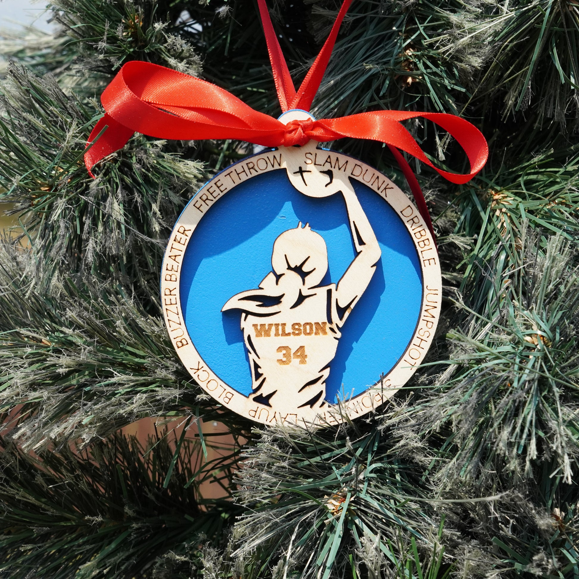 Ornament with a basketball player design on a Christmas tree