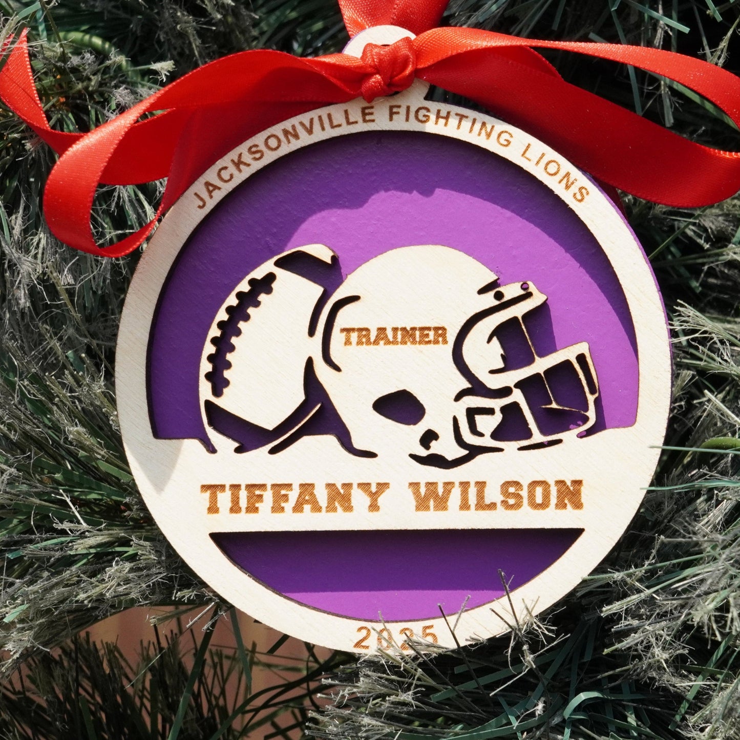 Ornament with football helmet design on a Christmas tree