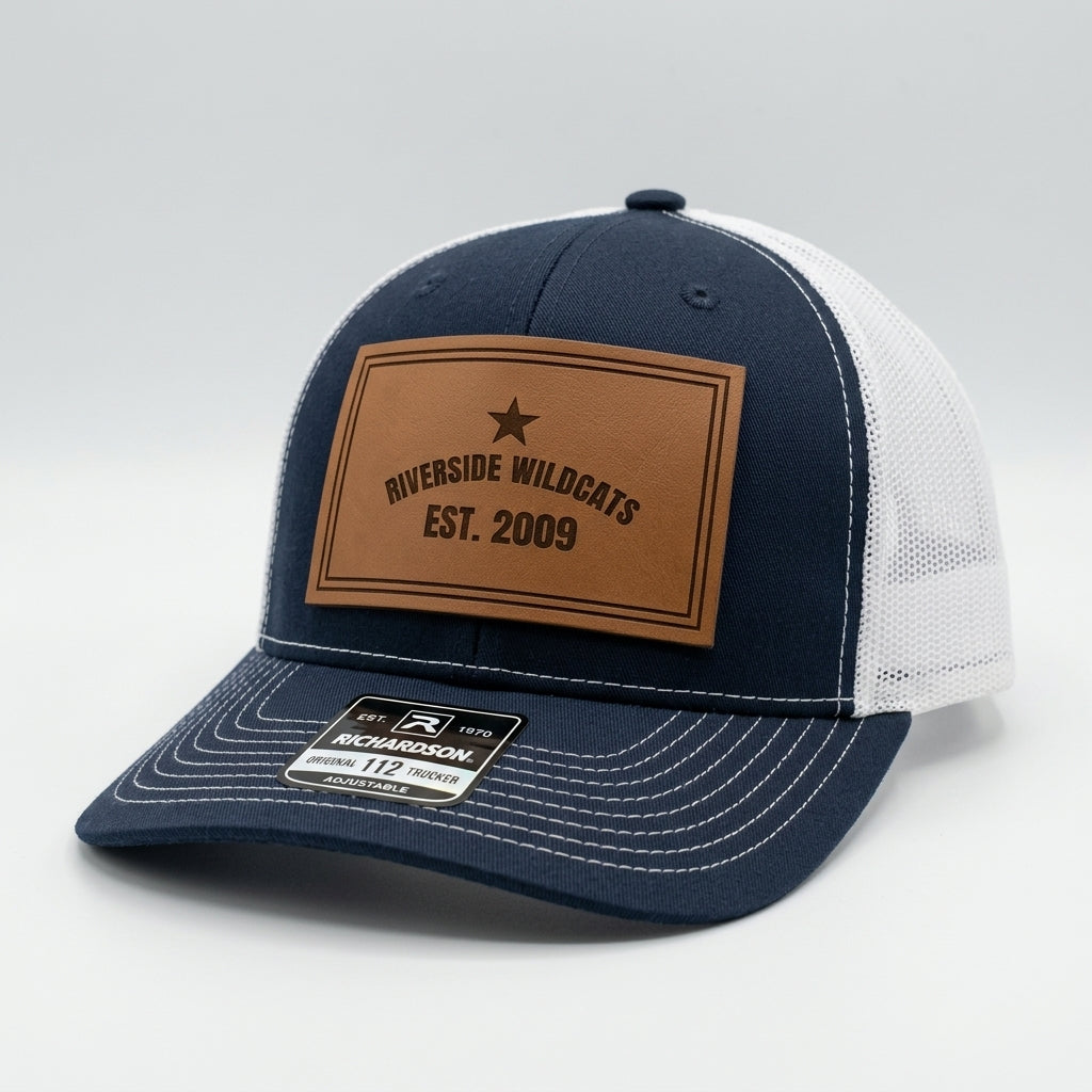 custom team hats with engraved wildcats logo patch on navy trucker cap