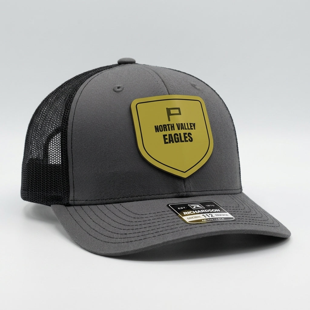 custom team hats with engraved eagles shield logo patch on charcoal trucker cap