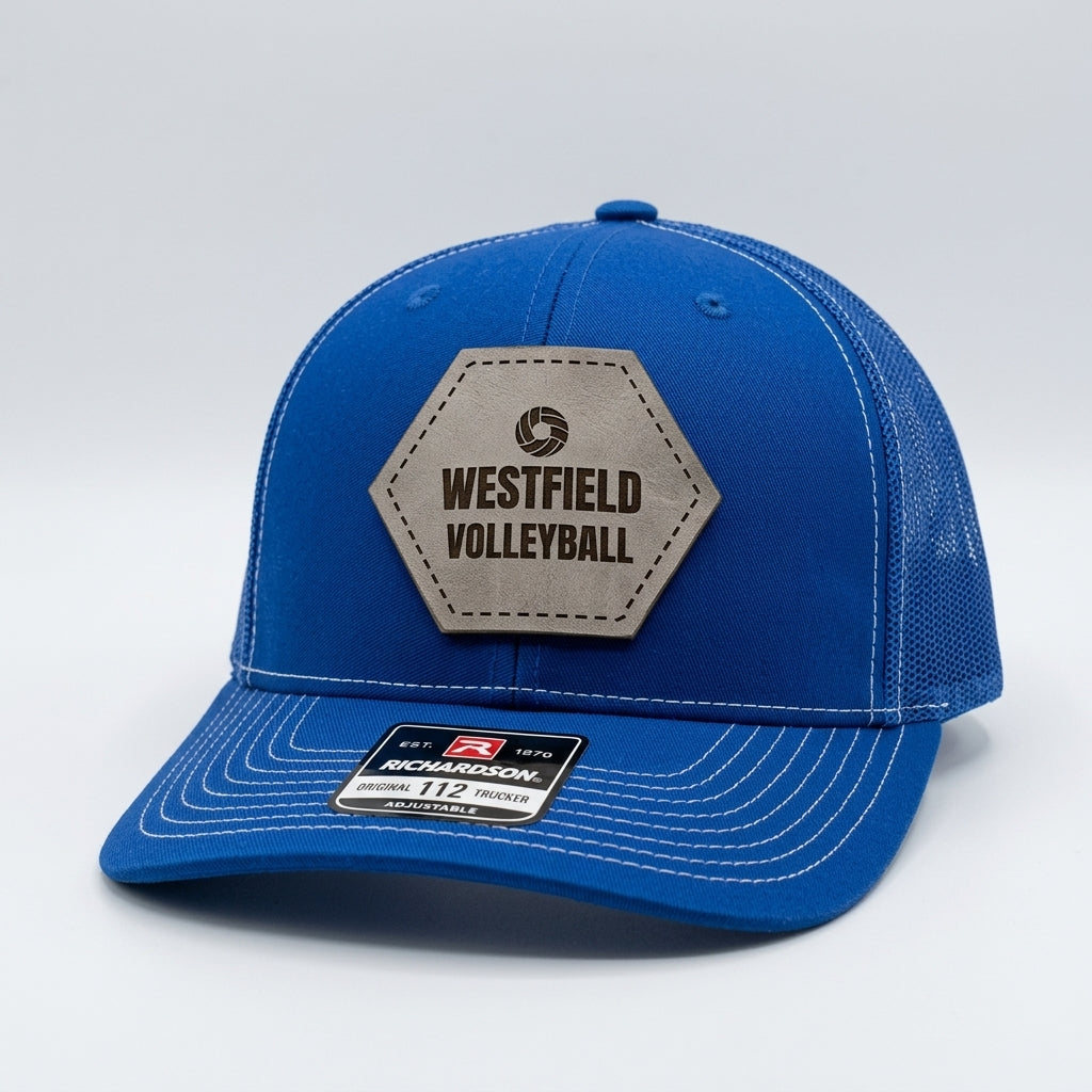 custom team hats with engraved volleyball logo patch on royal blue trucker cap