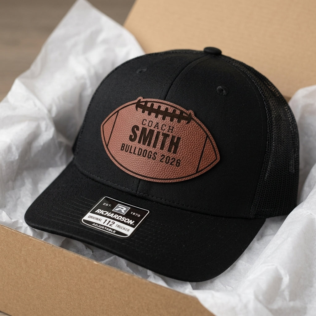 closeup of engraved coach name inside a football shaped patch