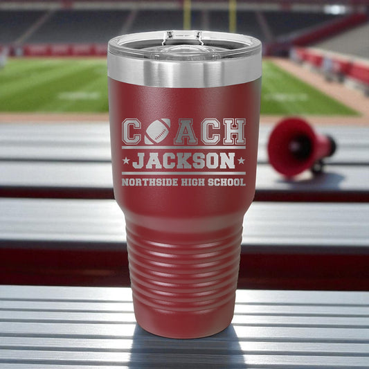 Red tumbler with 'Coach Jackson Northside High School' text on a stadium background