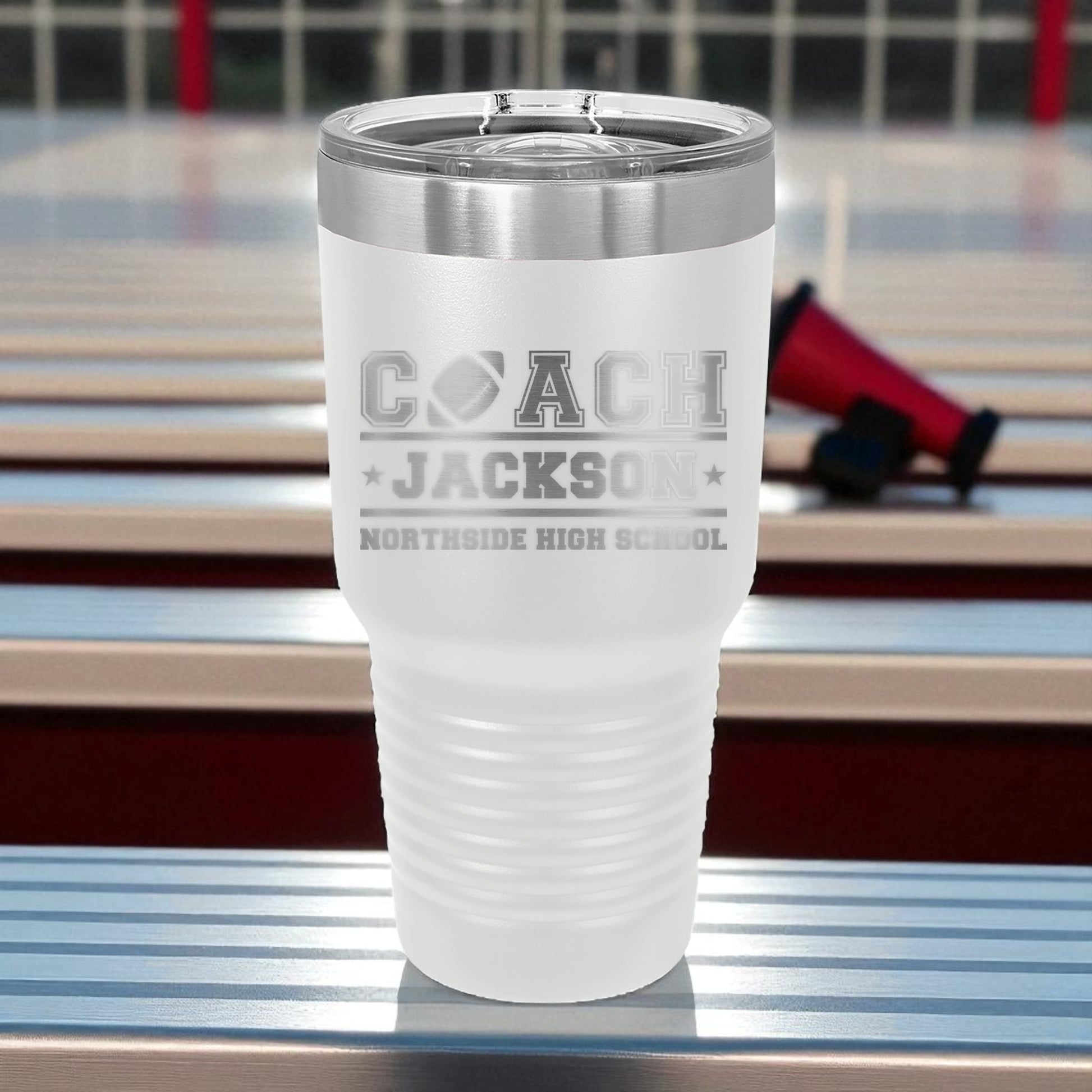 Frosted tumbler with engraved text on a reflective surface