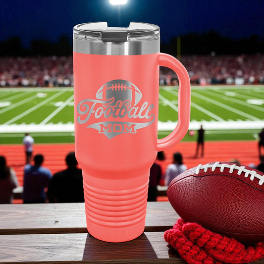 Pink travel mug with 'Football Mom' text on a football field background