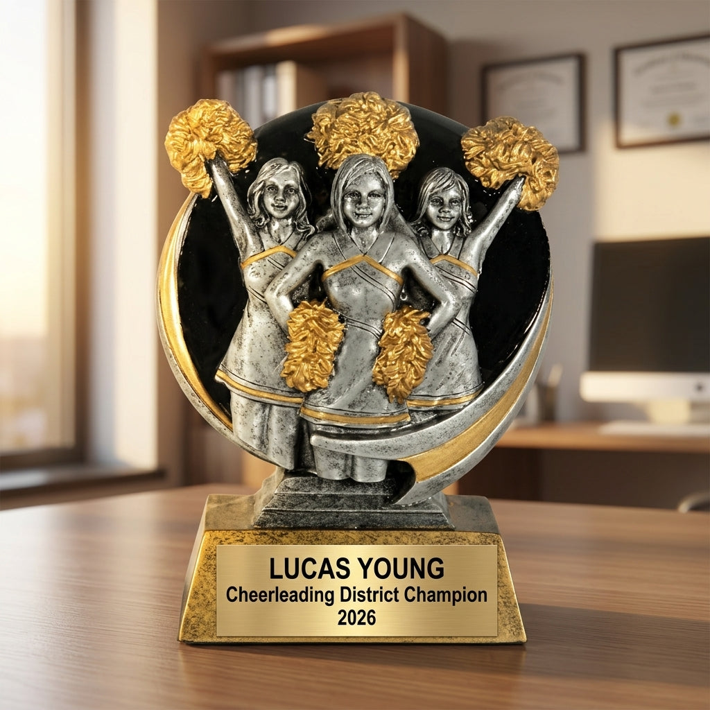 Close-up of laser-engraved gold nameplate on personalized cheerleading trophy showing custom name, achievement, and year