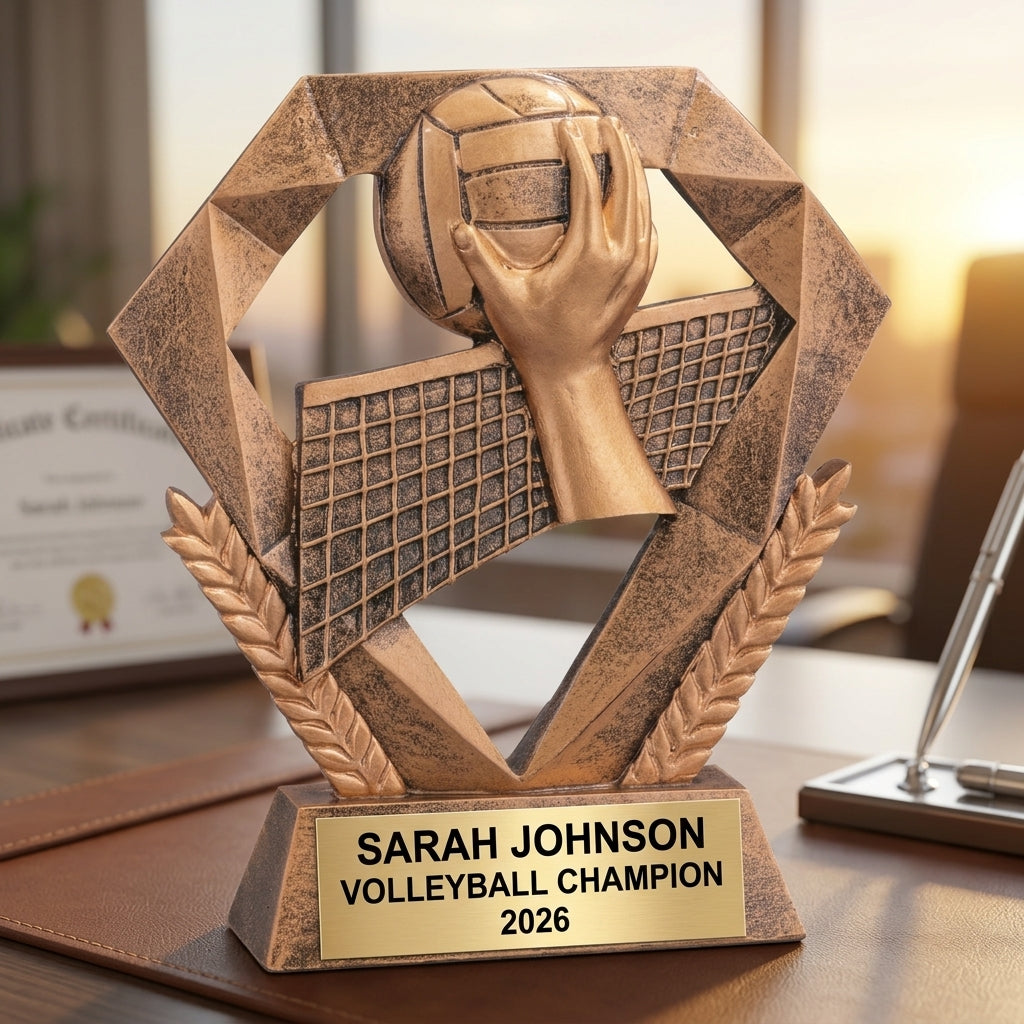 Close-up of laser-engraved gold nameplate on personalized volleyball trophy showing custom name, achievement, and year